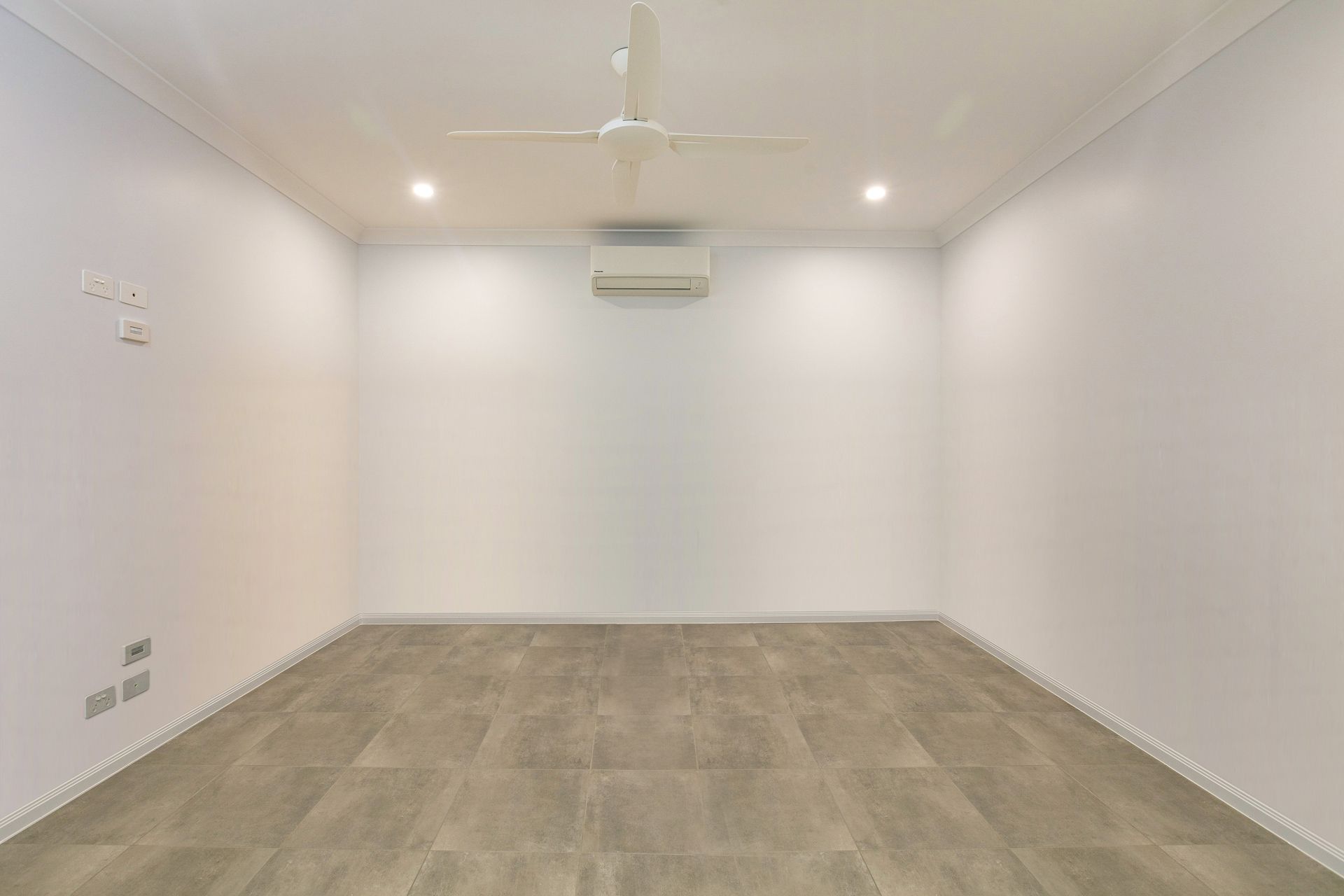 A Minimalist, Empty Room With Light Gray Walls — Ashlee Jones Homes in Gordonvale, QLD