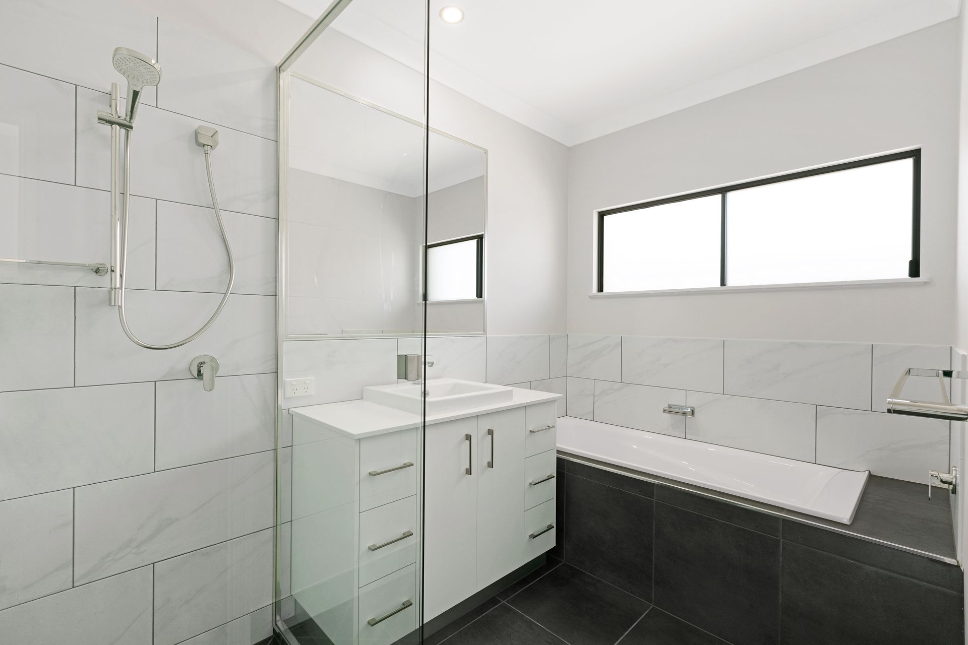 Modern Bathroom Featuring a White Vanity — Ashlee Jones Homes in Gordonvale, QLD