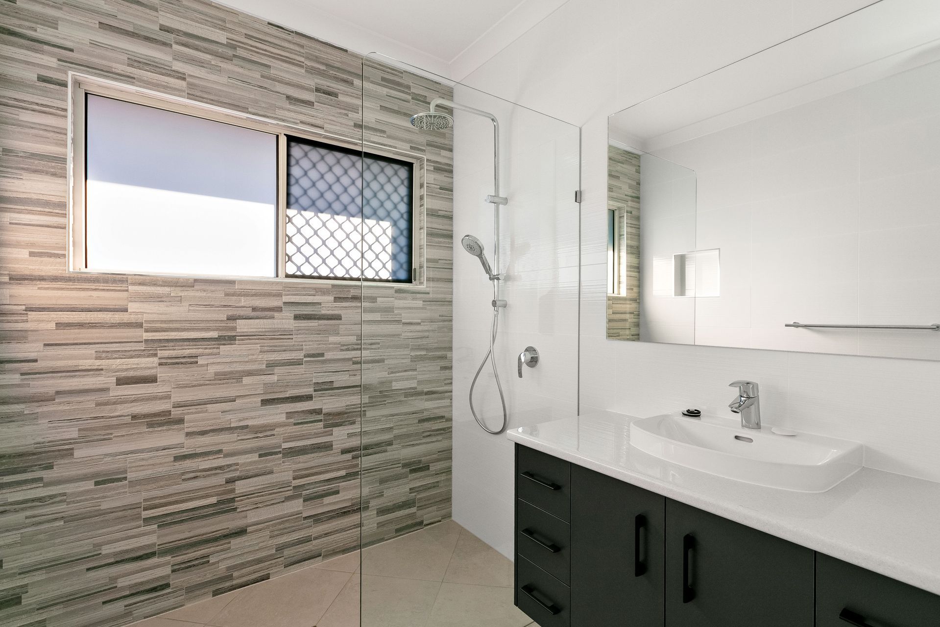 Modern Bathroom With Gray Textured Feature Wall — Ashlee Jones Homes in Gordonvale, QLD