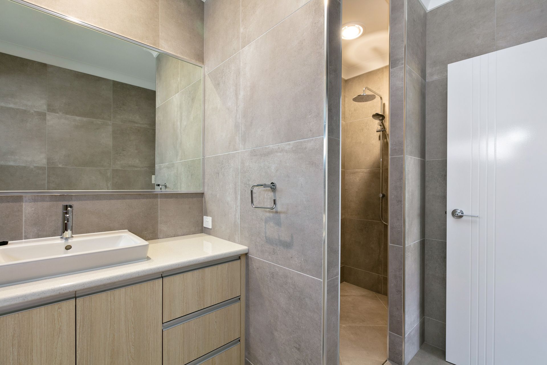 Modern Bathroom With a Light Wood Vanity, a Rectangular Sink — Ashlee Jones Homes in Gordonvale, QLD