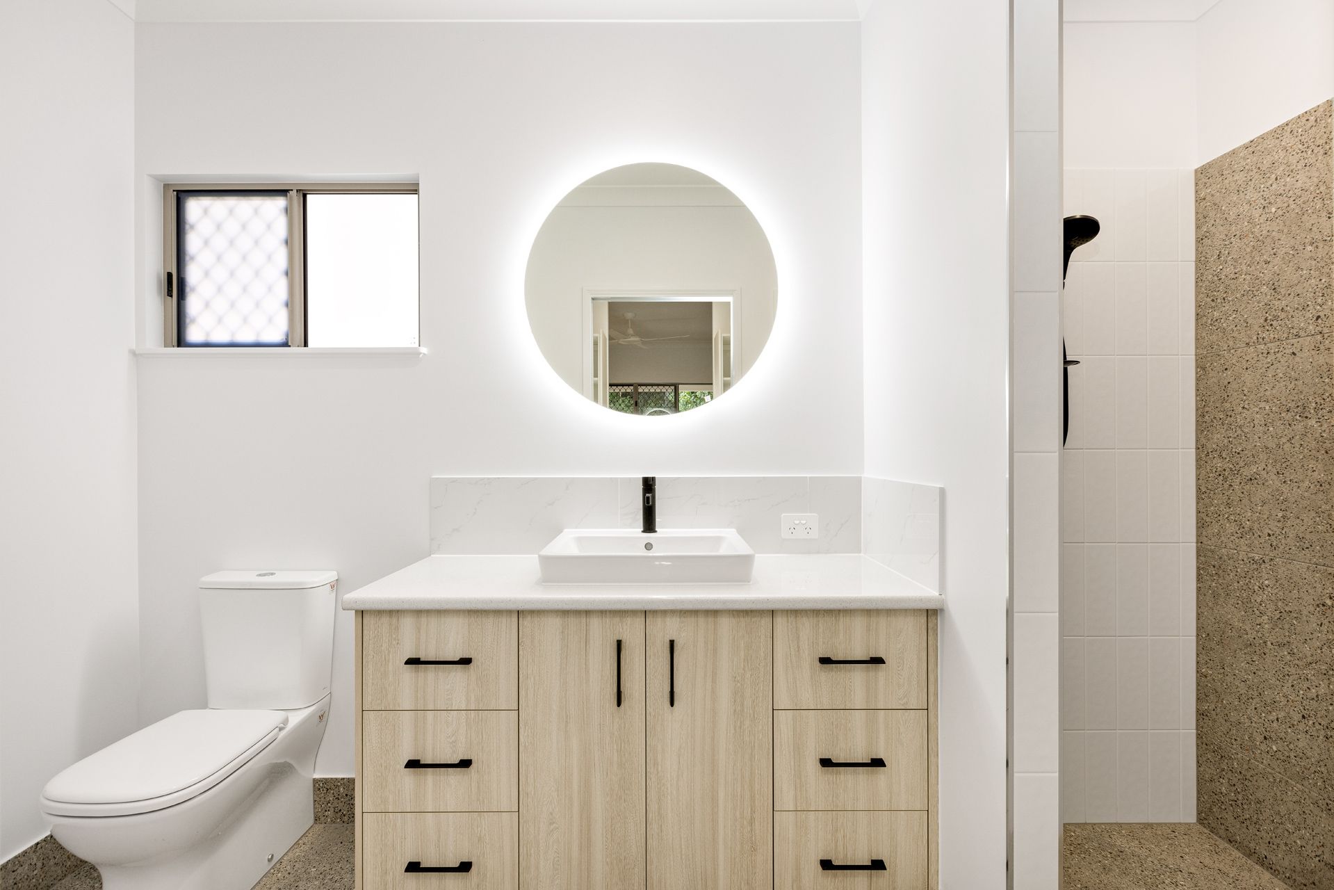 A Modern Bathroom With a Light Wood Vanity — Ashlee Jones Homes in Gordonvale, QLD