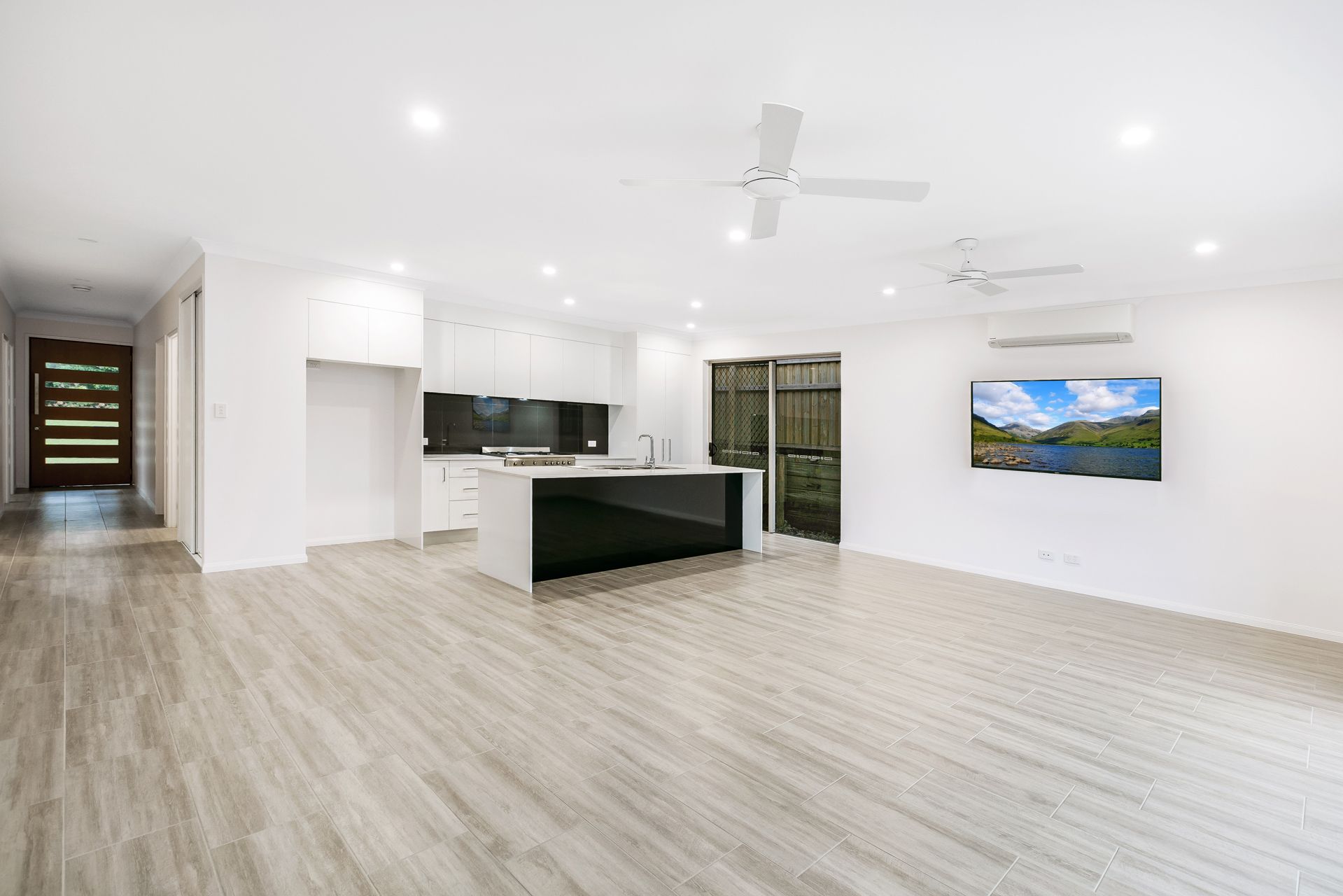 Modern Open-plan Living Area With White Walls — Ashlee Jones Homes in Gordonvale, QLD
