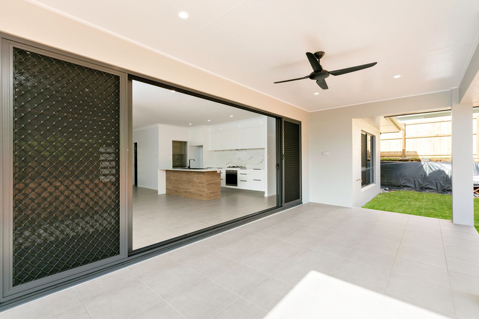 A Covered Outdoor Patio With a Ceiling Fan — Ashlee Jones Homes in Gordonvale, QLD