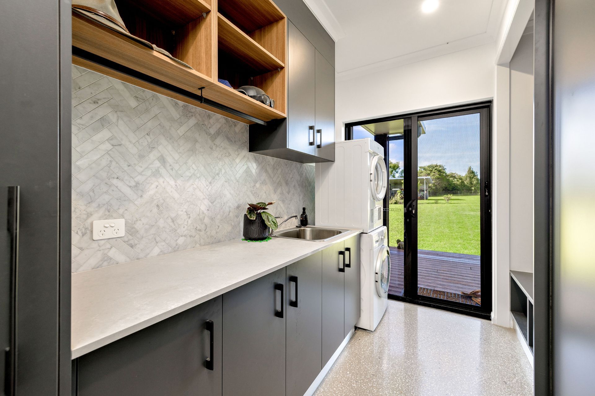 Modern Laundry Room With Gray Cabinets, White Countertop — Ashlee Jones Homes in Gordonvale, QLD