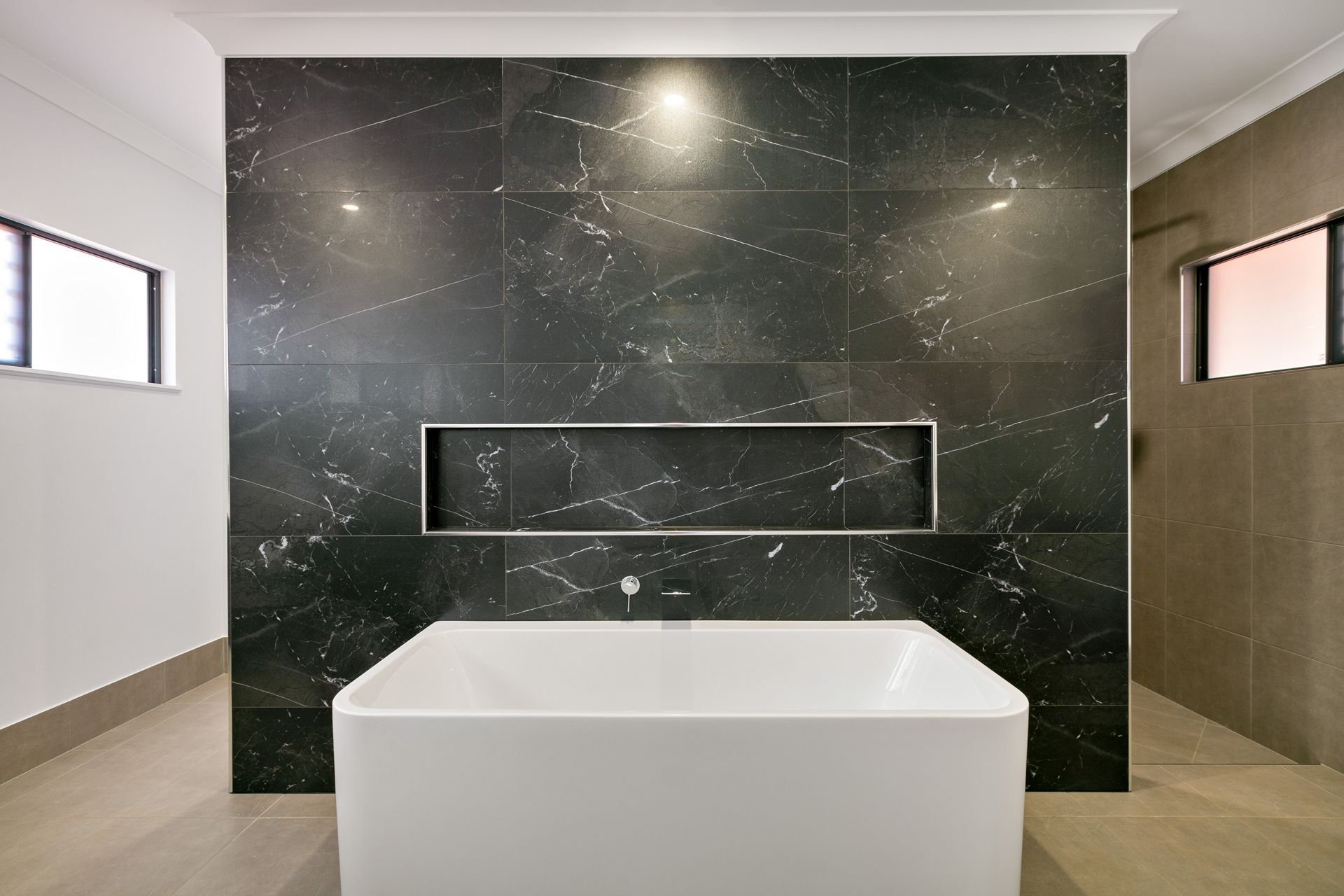 A White Standalone Bathtub Sits in Front of a Dark — Ashlee Jones Homes in Gordonvale, QLD