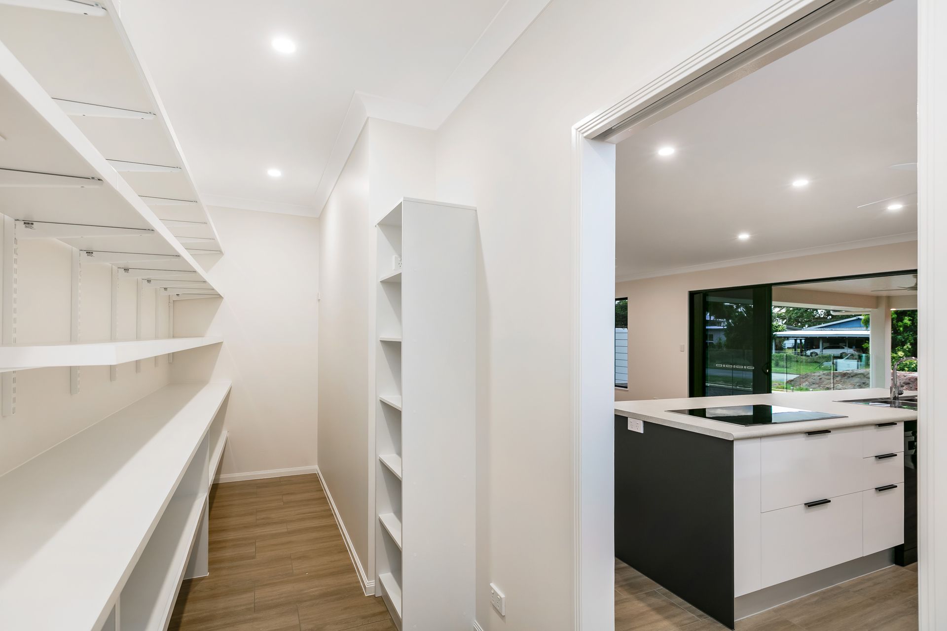 A Vacant Room With White Walls, Wood-look Flooring — Ashlee Jones Homes in Gordonvale, QLD