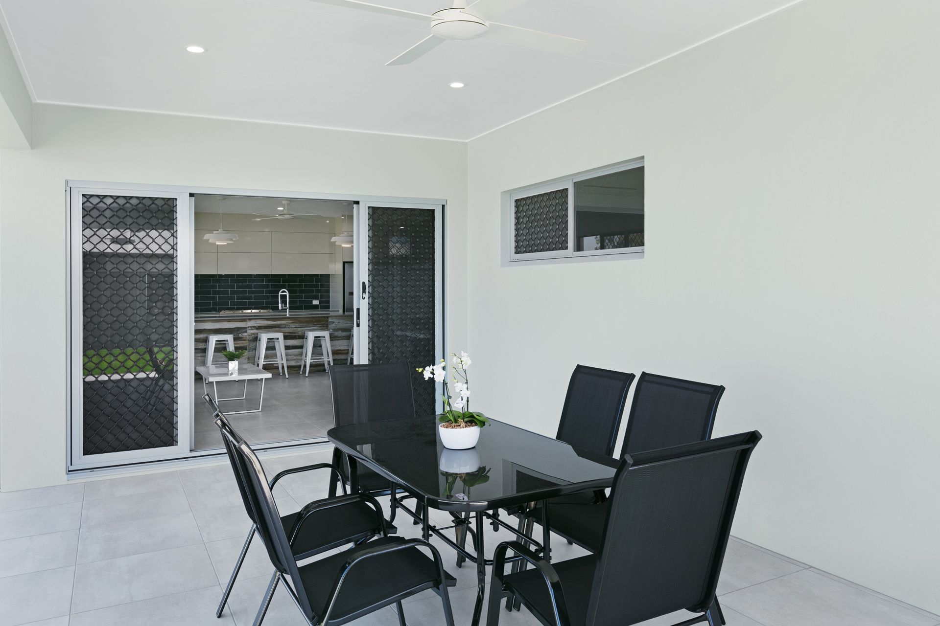 An Outdoor Covered Patio Features a Black Dining Set — Ashlee Jones Homes in Gordonvale, QLD