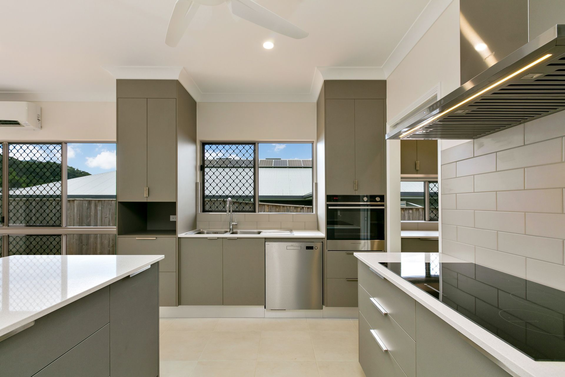 Modern Kitchen With Neutral Cabinets, Stone Countertops — Ashlee Jones Homes in Gordonvale, QLD