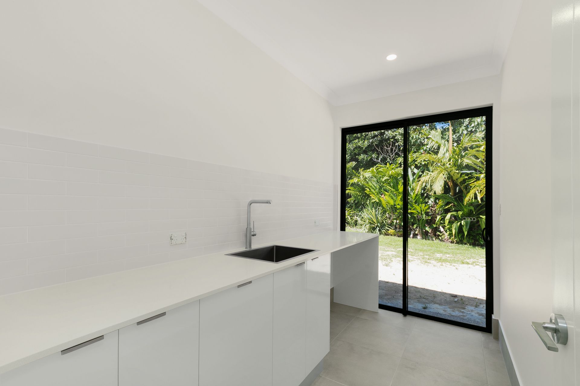 A Modern, Minimalist White Kitchenette With a Sink — Ashlee Jones Homes in Gordonvale, QLD