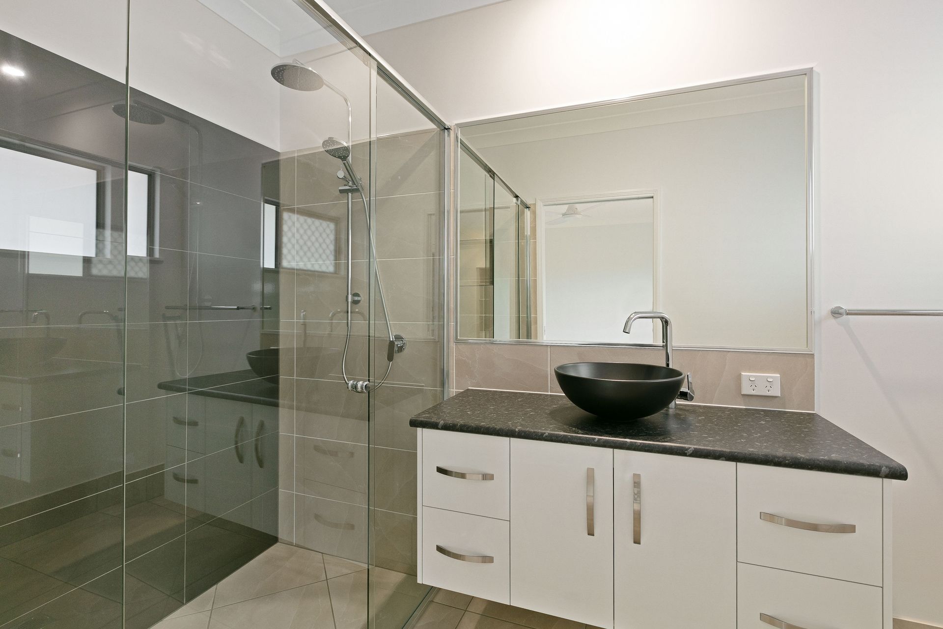 A Modern Bathroom Featuring a Walk-in Glass Shower — Ashlee Jones Homes in Gordonvale, QLD
