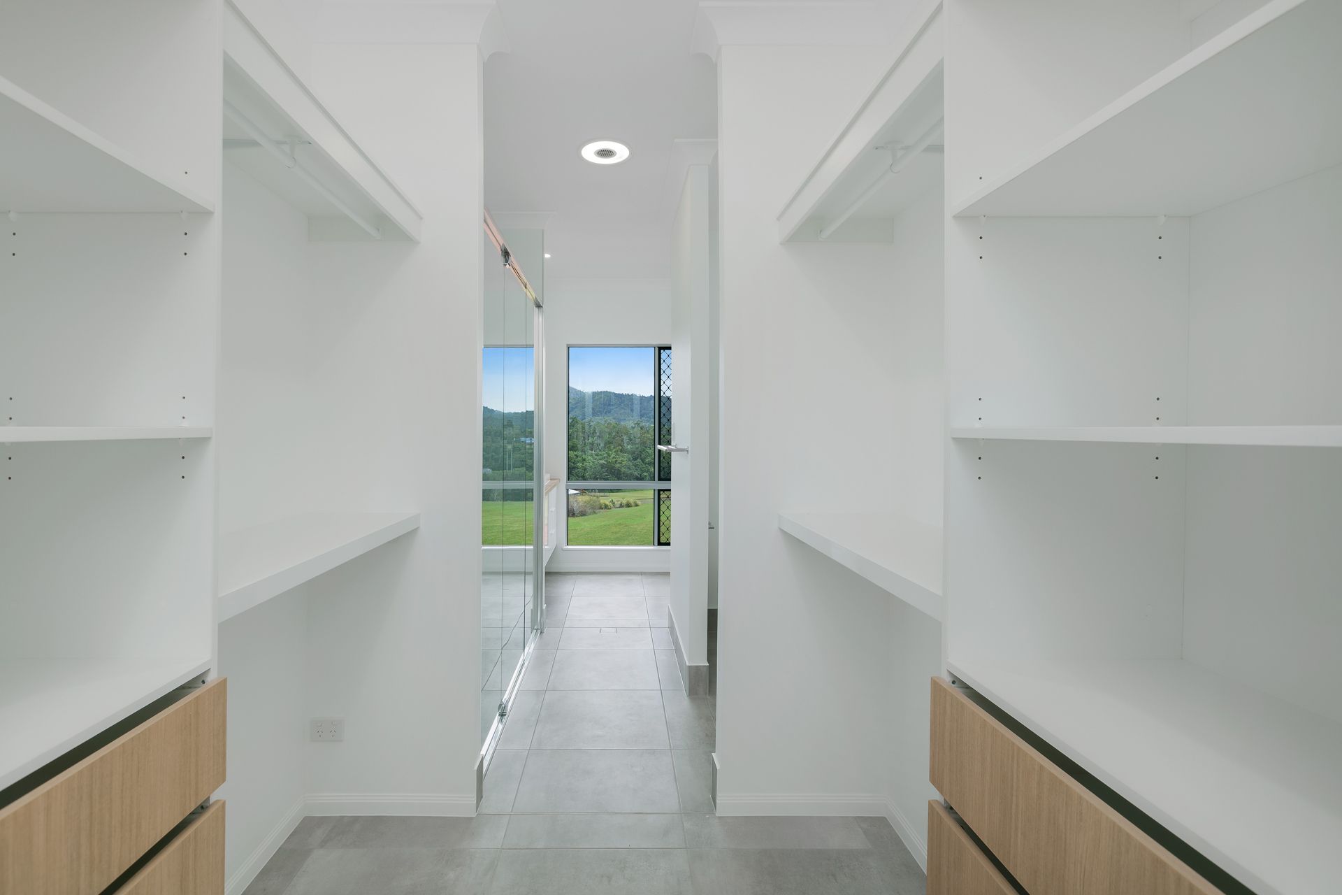 Modern White Walk-in Closet With Open Shelves — Ashlee Jones Homes in Gordonvale, QLD