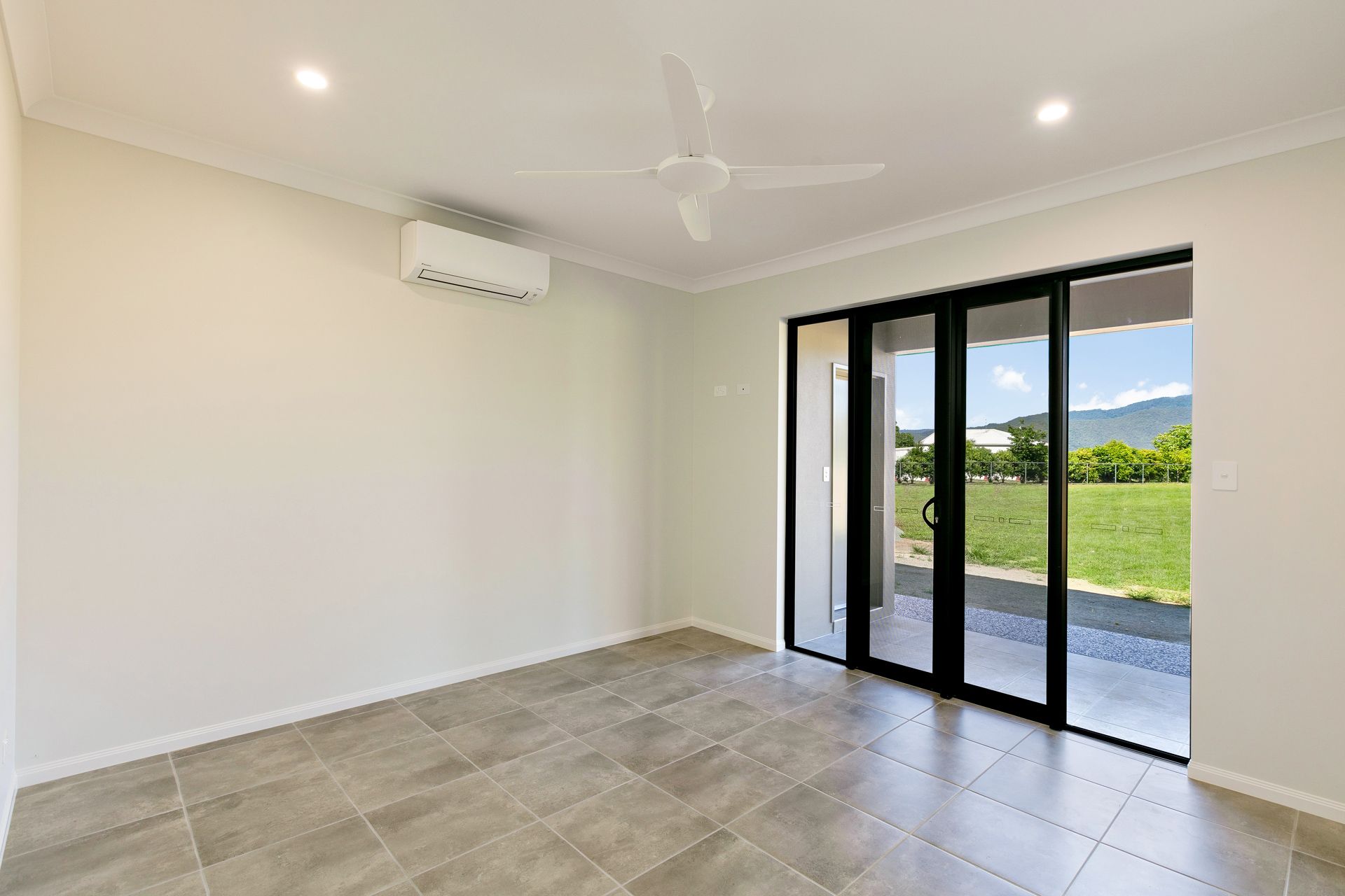 An Empty Room With Tiled Flooring, White Walls — Ashlee Jones Homes in Gordonvale, QLD