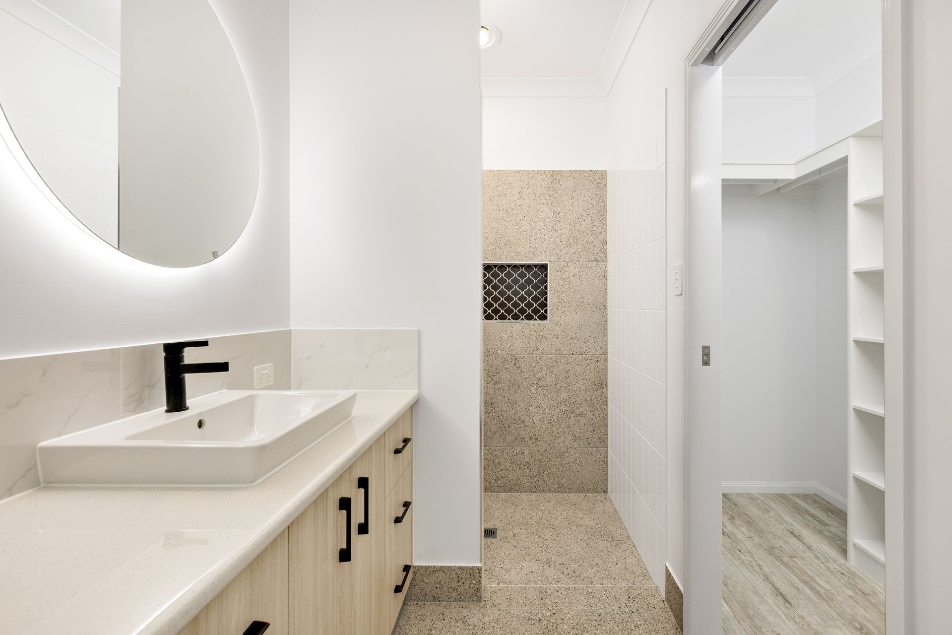 Modern Bathroom With a White Vanity, Black Faucet — Ashlee Jones Homes in Gordonvale, QLD