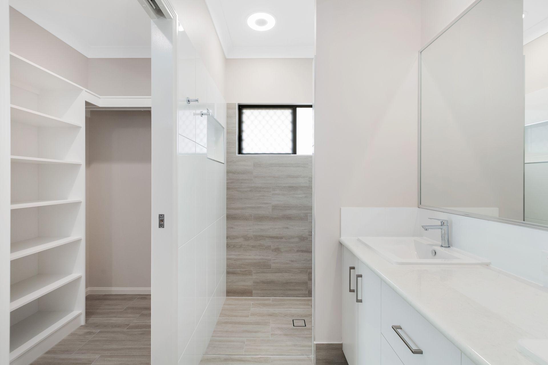 A Modern Bathroom Featuring a White Vanity With a Sink — Ashlee Jones Homes in Gordonvale, QLD