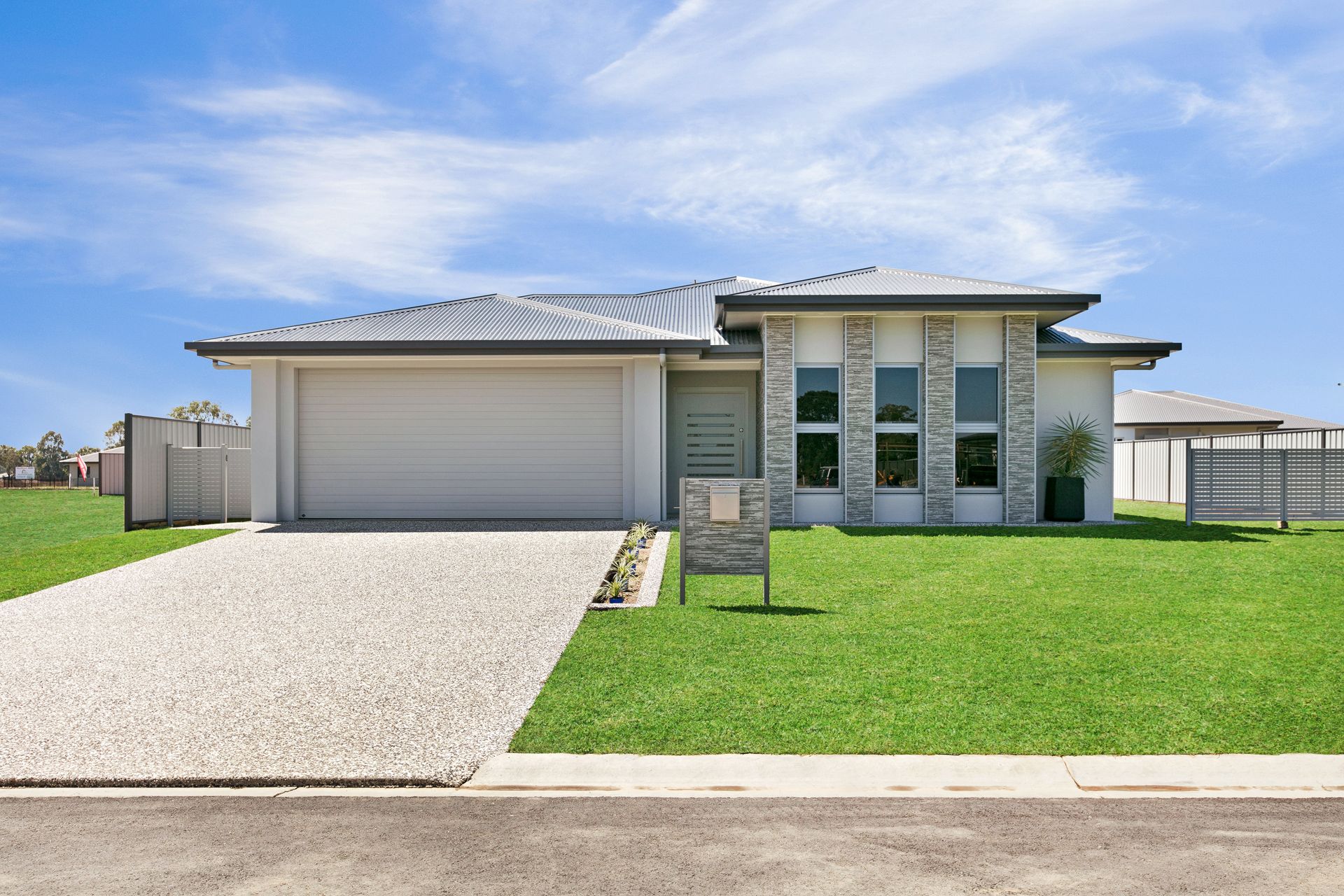A Modern, Single-story House With a Light-colored Facade — Ashlee Jones Homes in Gordonvale, QLD