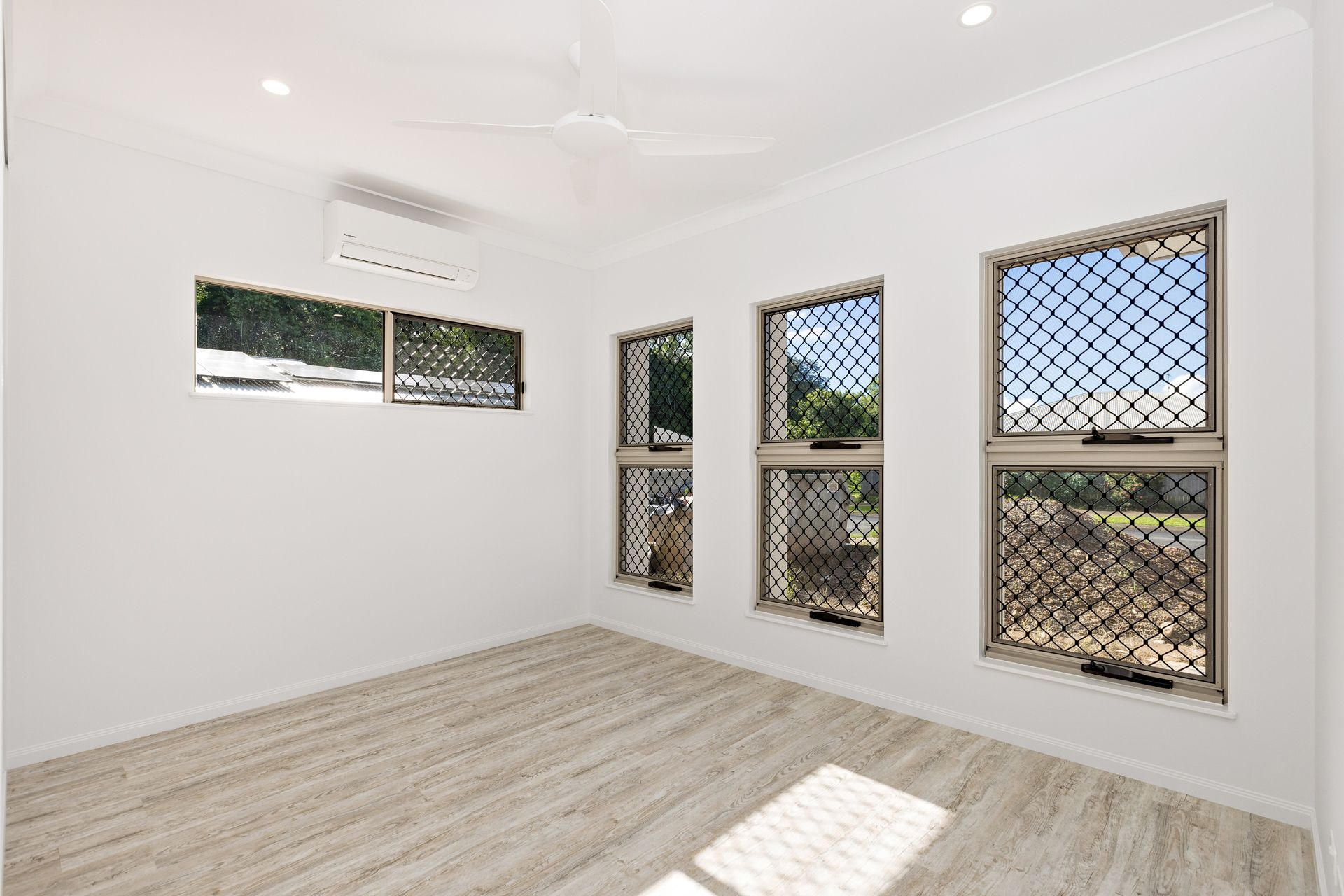 Empty Room With Light-colored Wood Flooring, White Walls — Ashlee Jones Homes in Gordonvale, QLD