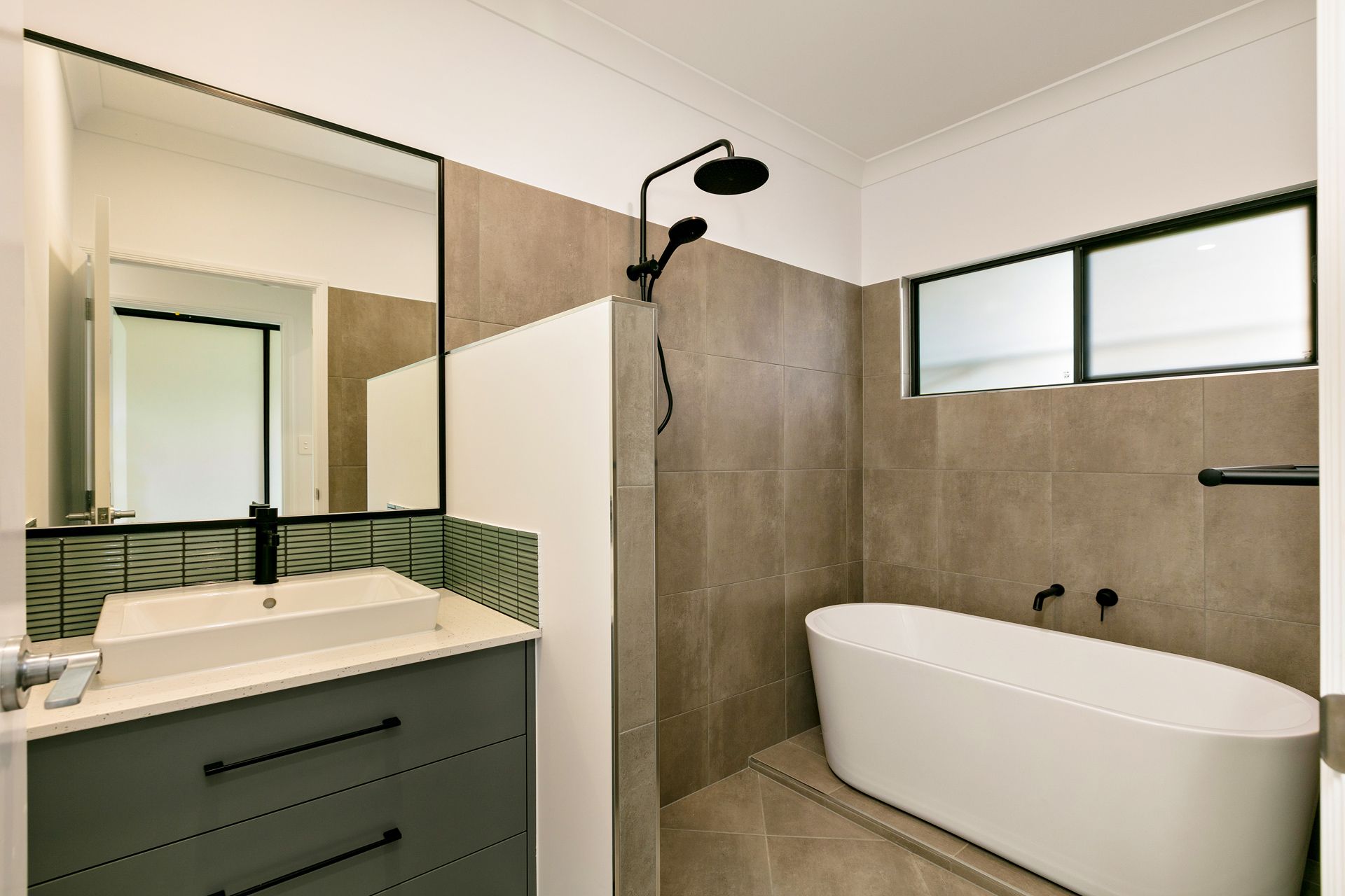 A Modern Bathroom With a Grey Vanity, a Rectangular Sink — Ashlee Jones Homes in Gordonvale, QLD