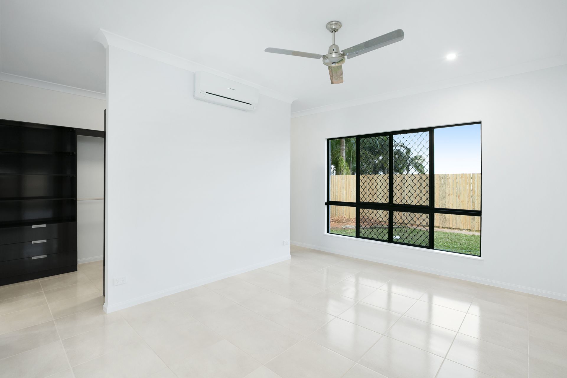 An Unfurnished Room With White Walls, Tiled Floors — Ashlee Jones Homes in Gordonvale, QLD