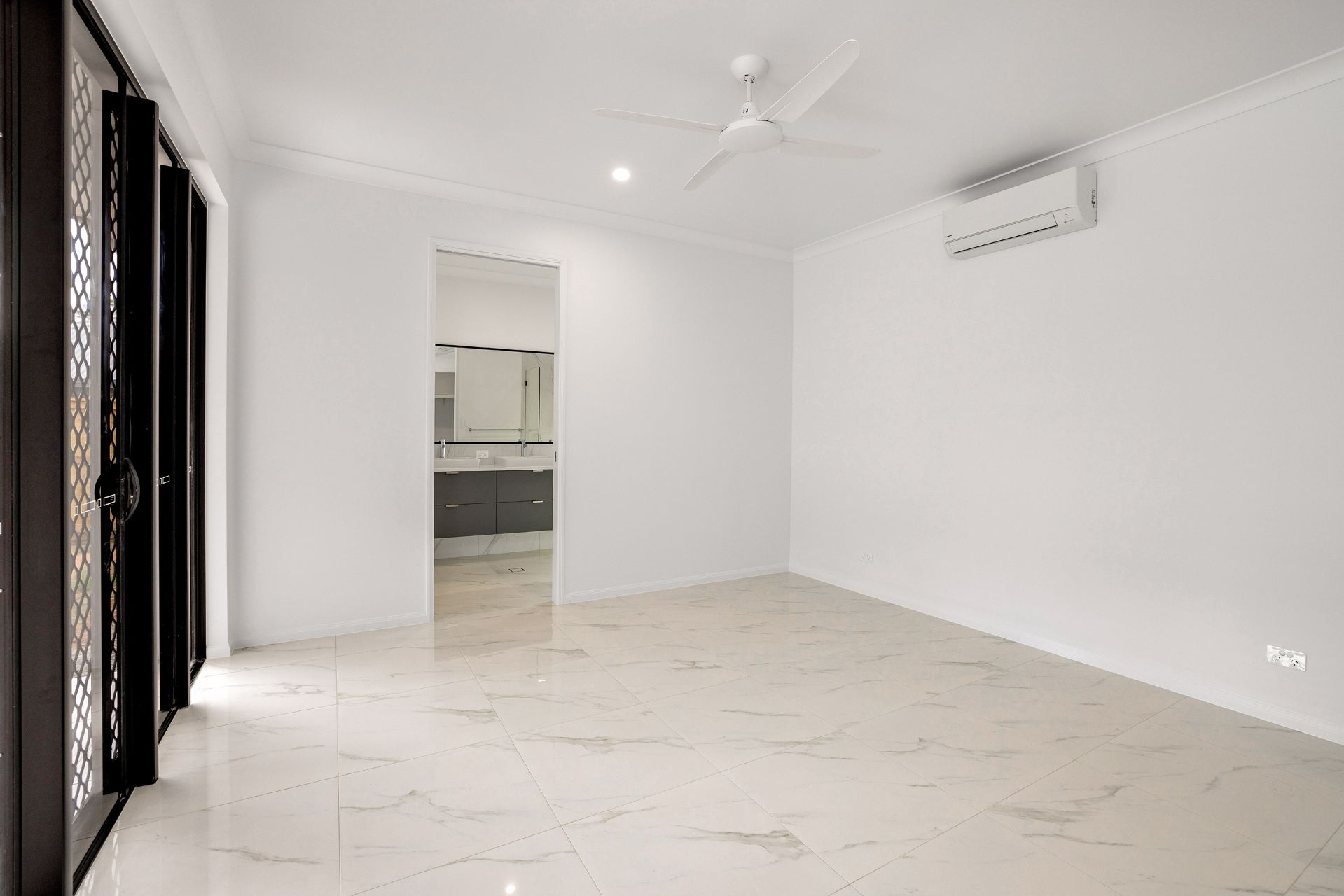 Empty, White-walled Room With Glossy Marble-tiled Floors — Ashlee Jones Homes in Gordonvale, QLD