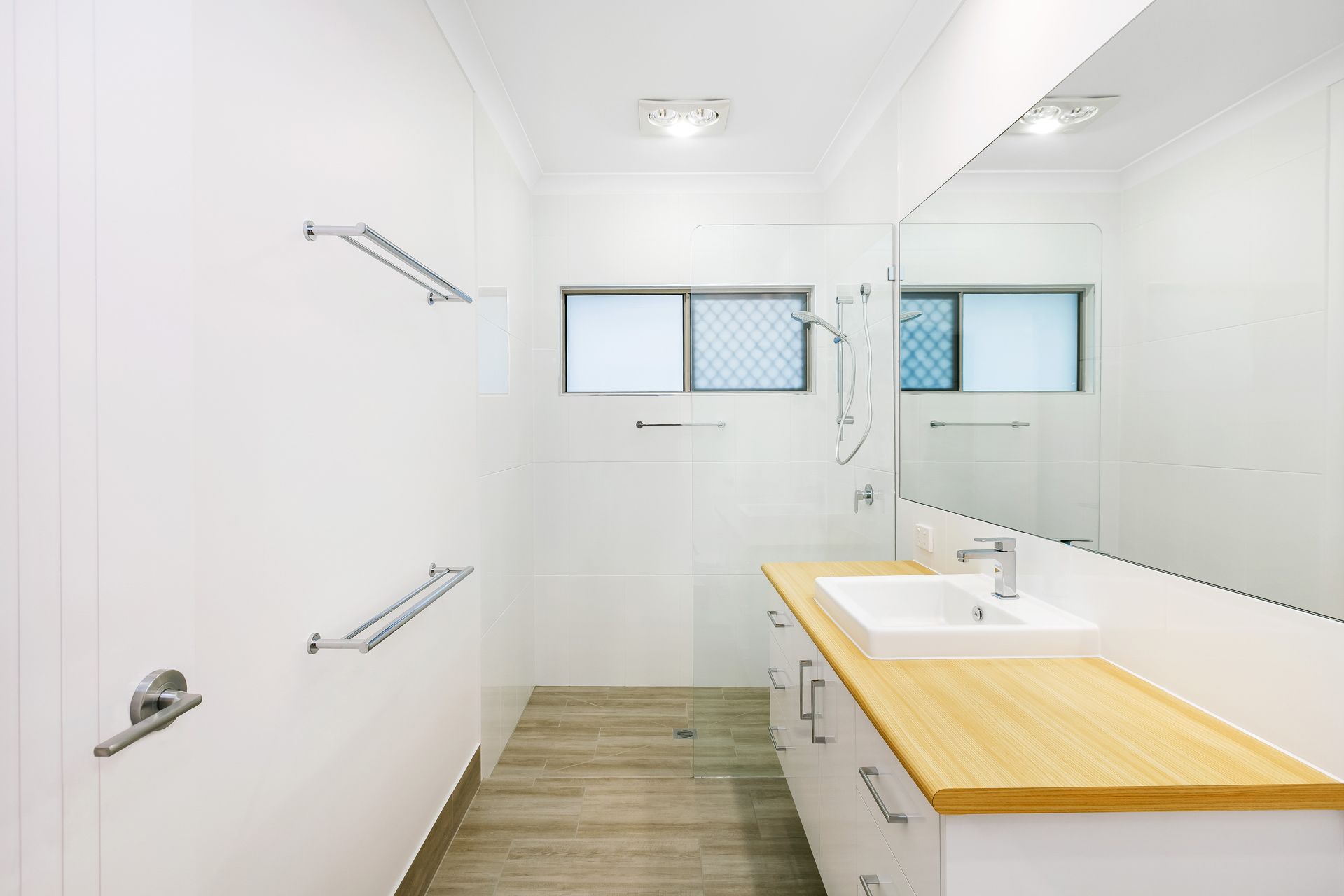 A Modern, Bright Bathroom With White Walls — Ashlee Jones Homes in Gordonvale, QLD
