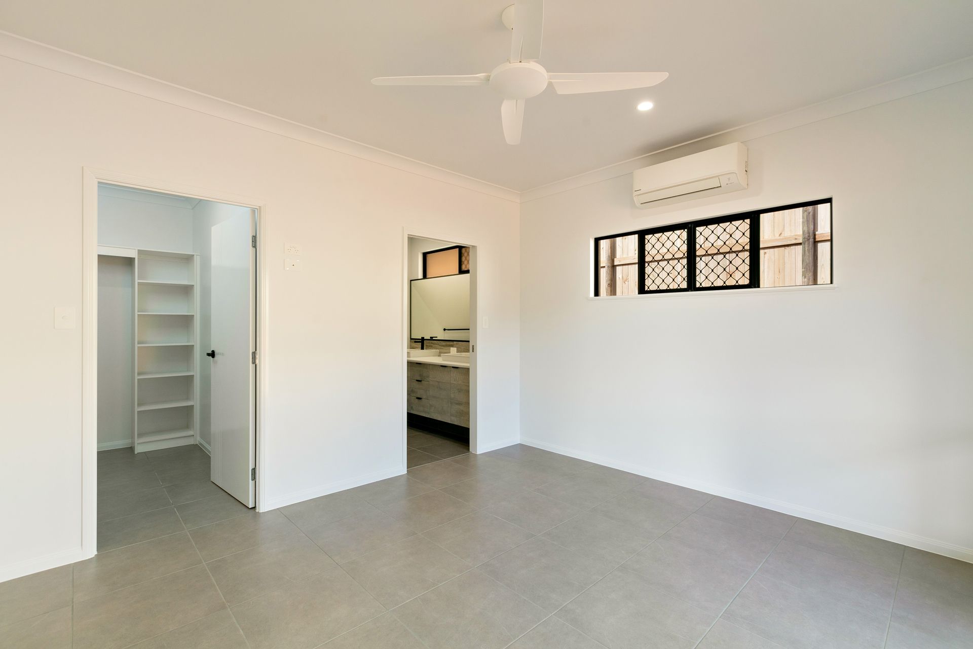 A Minimalist, Empty Bedroom With White Walls — Ashlee Jones Homes in Gordonvale, QLD