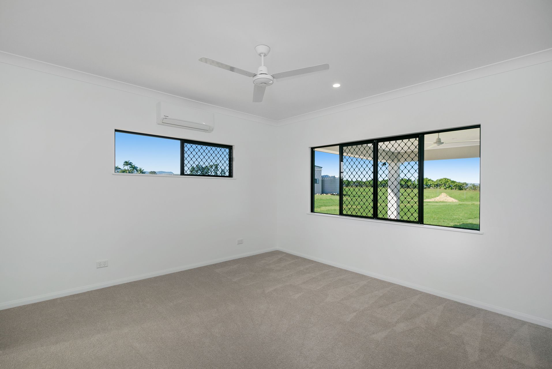 An Empty Room With White Walls, Gray Carpet — Ashlee Jones Homes in Gordonvale, QLD