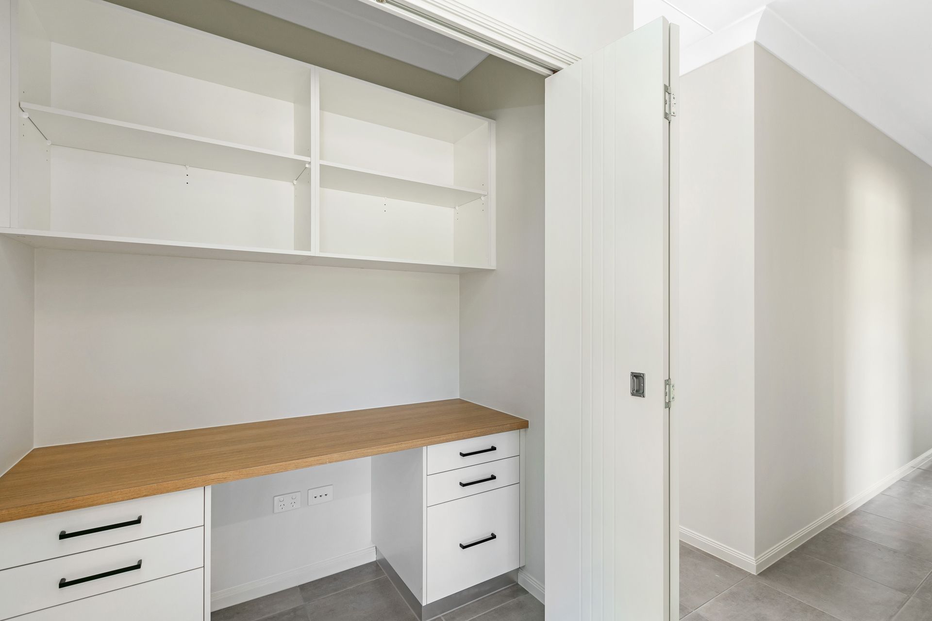 A Built-in Home Office Nook Featuring White Cabinets — Ashlee Jones Homes in Gordonvale, QLD