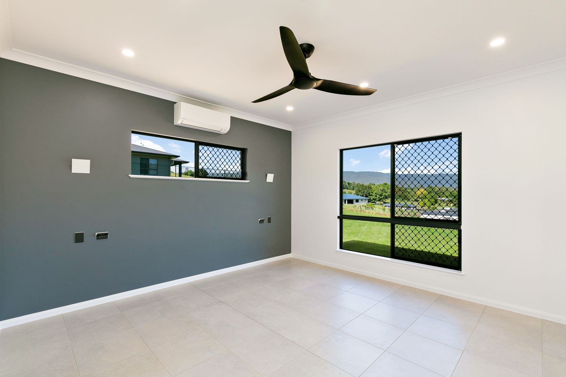 An Empty Room With Light Tile Floors, White Walls — Ashlee Jones Homes in Gordonvale, QLD