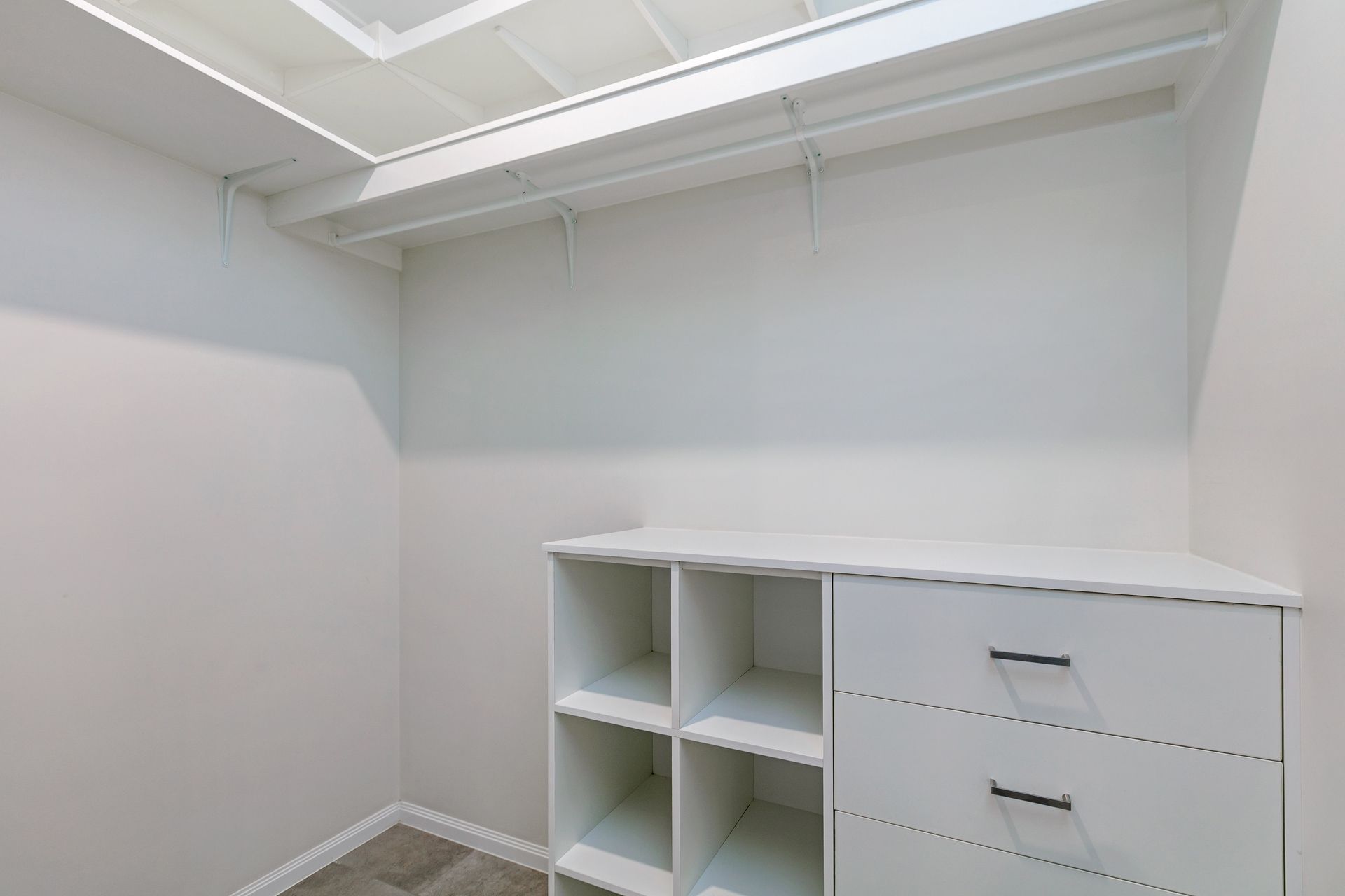 A Walk-in Closet Featuring White Walls, a Shelf With a Clothing Rod — Ashlee Jones Homes in Gordonvale, QLD