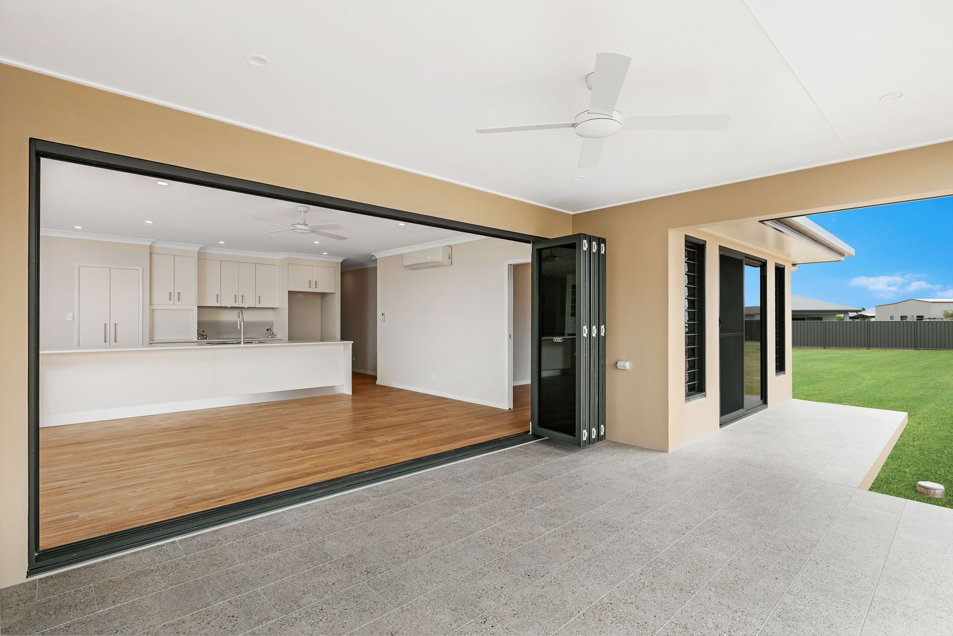 A Seamless Indoor-outdoor Living Space With a Kitchen Visible — Ashlee Jones Homes in Gordonvale, QLD