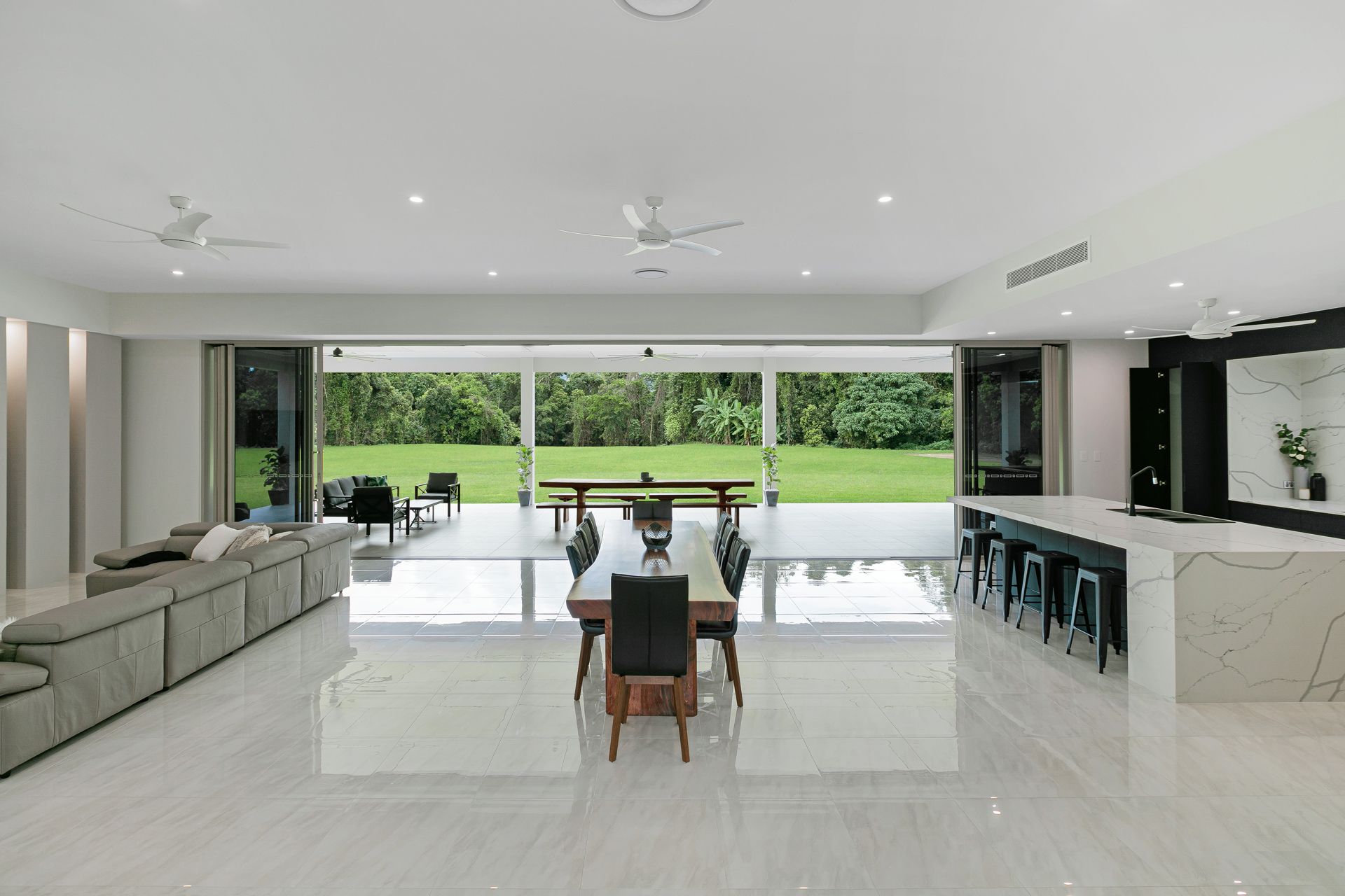 A Spacious, Modern Open-plan Home Interior Featuring a Kitchen Island — Ashlee Jones Homes in Gordonvale, QLD