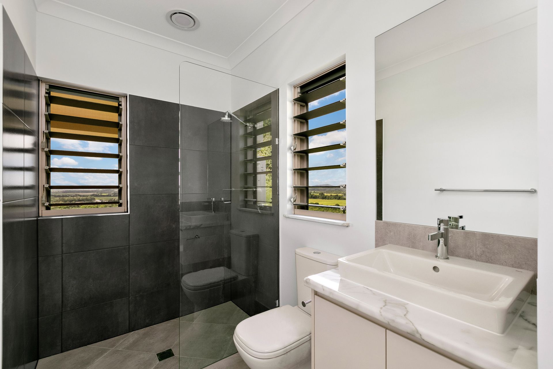 Modern Bathroom With Charcoal Tiled Shower — Ashlee Jones Homes in Gordonvale, QLD