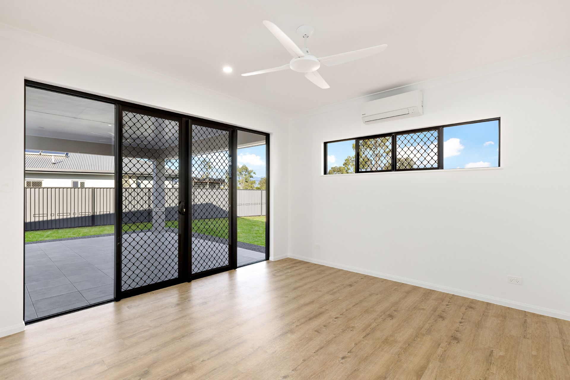 Modern Room With Wood Flooring, White Walls — Ashlee Jones Homes in Gordonvale, QLD