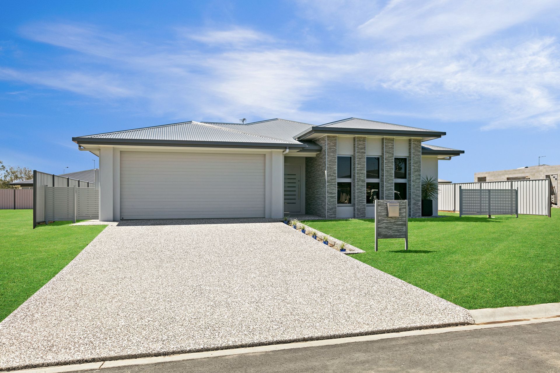A Modern Single-story Suburban House With a Large Light-gray Garage — Ashlee Jones Homes in Gordonvale, QLD