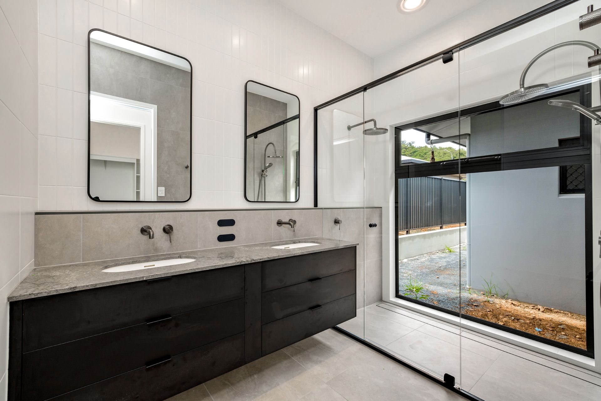 Modern Bathroom With a Dual-sink Dark Wood Vanity — Ashlee Jones Homes in Gordonvale, QLD