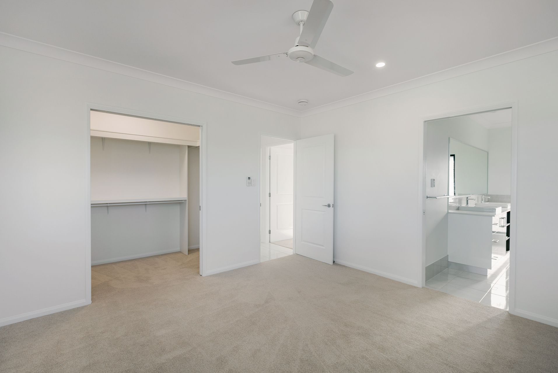 A Bright, Empty Bedroom With White Walls — Ashlee Jones Homes in Gordonvale, QLD