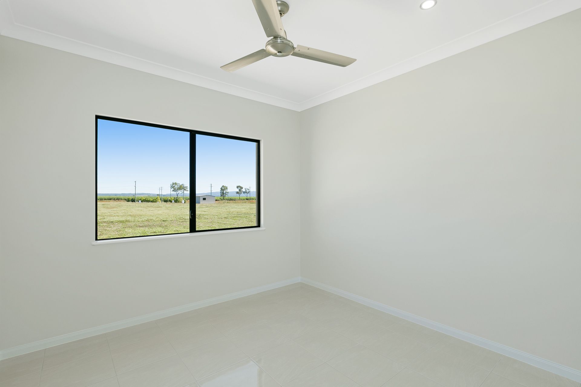 A Minimalist Empty Room With Light Walls — Ashlee Jones Homes in Gordonvale, QLD