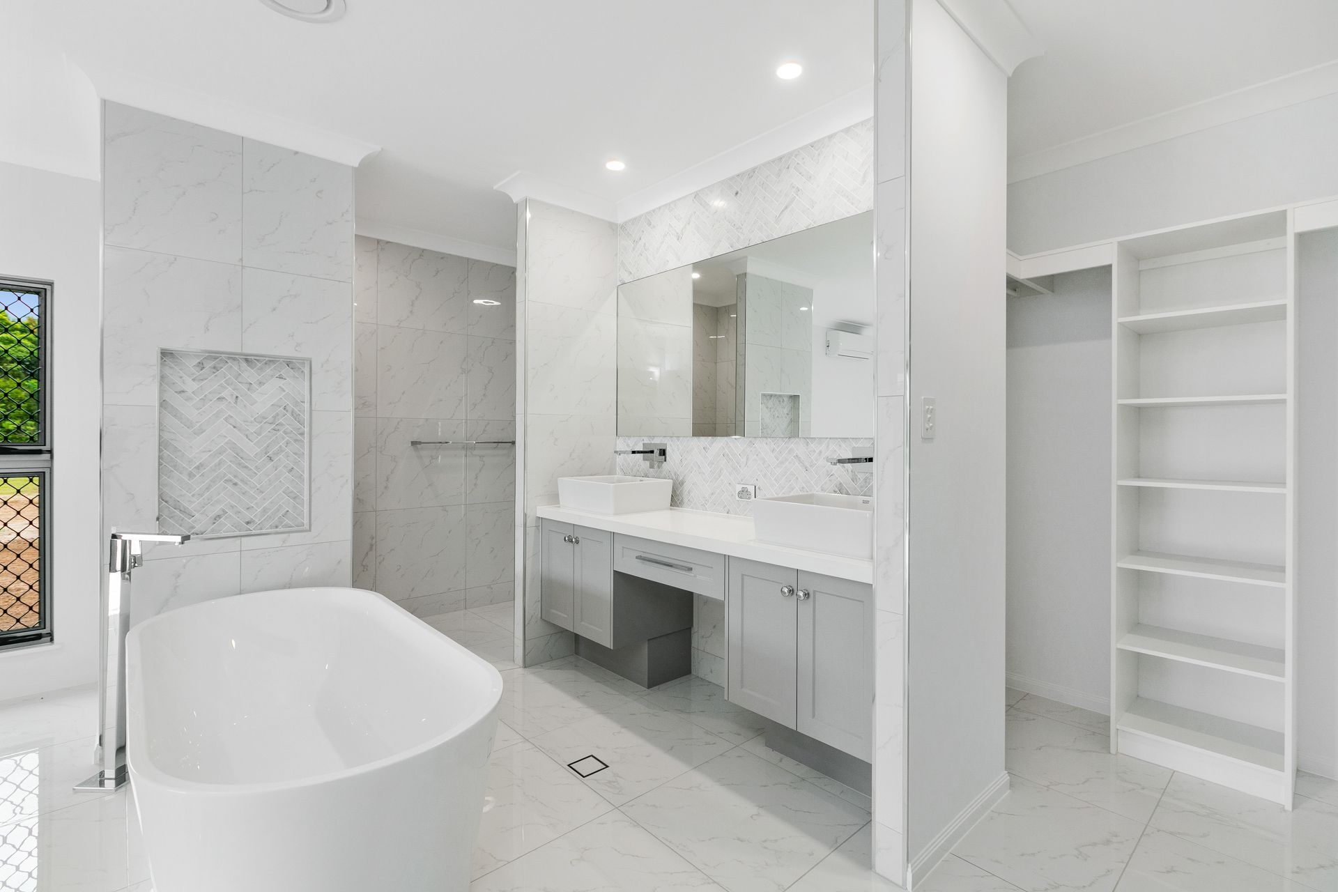 A Modern, Bright Bathroom With a White Freestanding Tub — Ashlee Jones Homes in Gordonvale, QLD