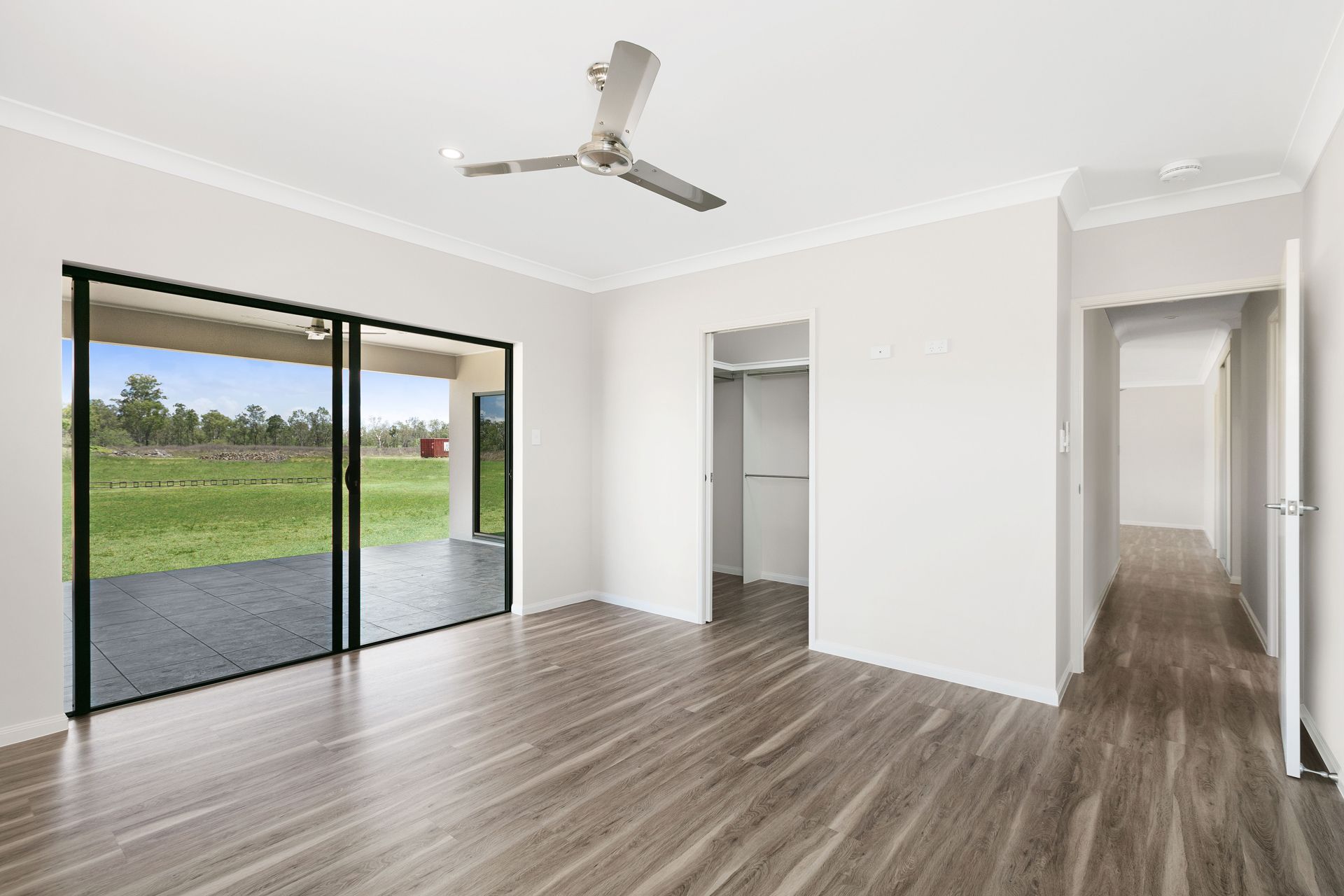 Empty Bedroom With Light Grey Wood-look Flooring — Ashlee Jones Homes in Gordonvale, QLD