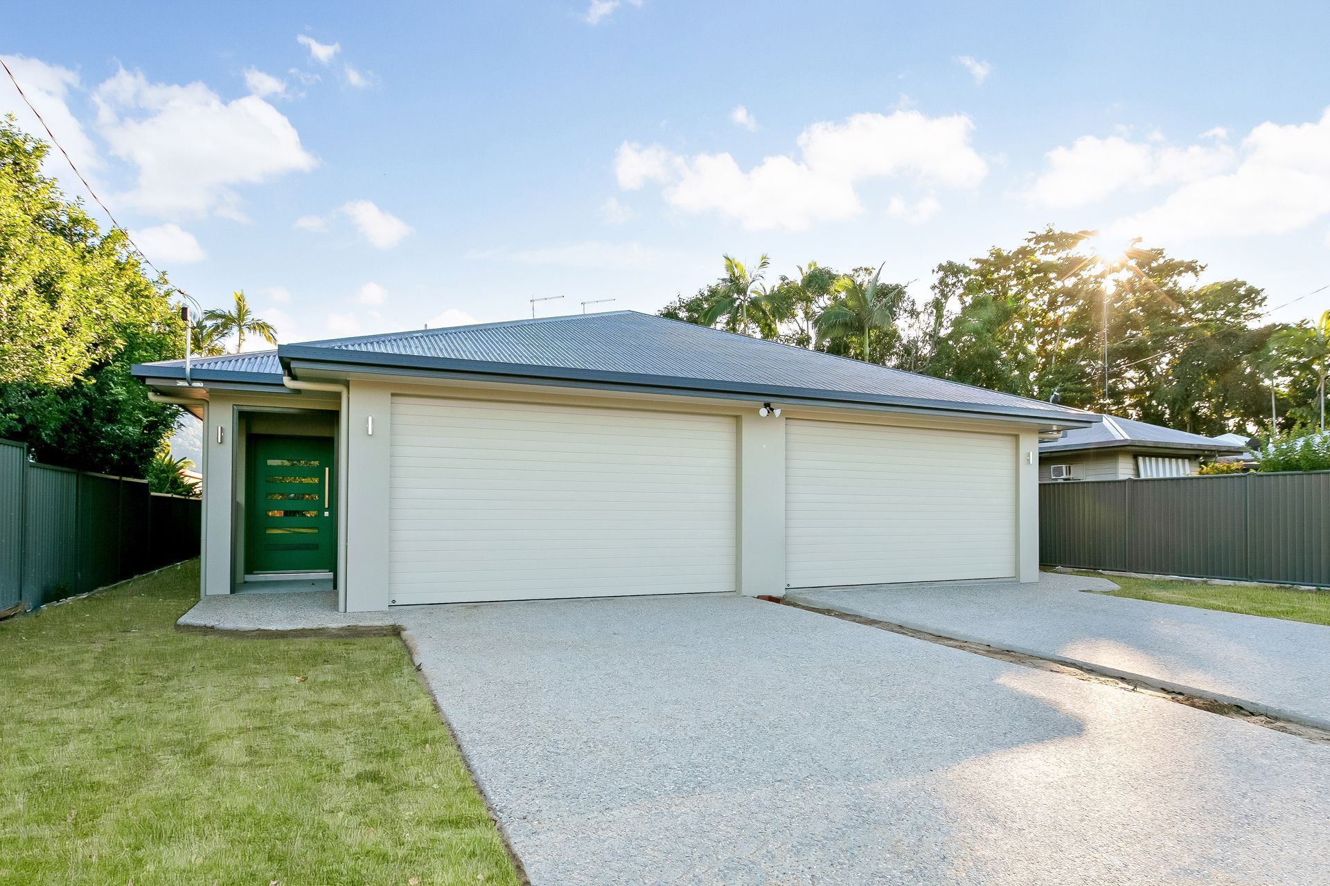 Single-story Duplex Home With Two Beige Garage Doors — Ashlee Jones Homes in Gordonvale, QLD