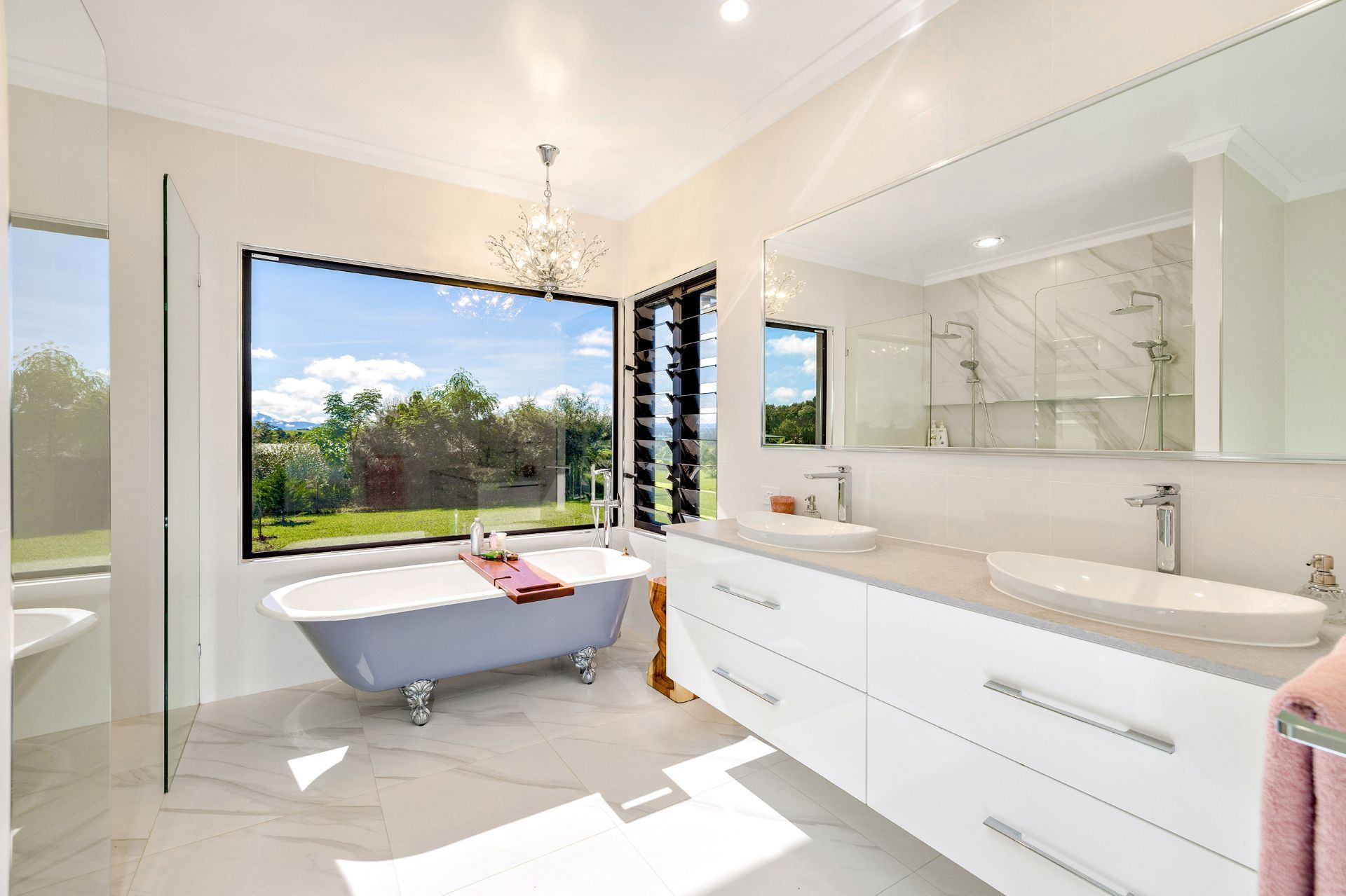 A Modern, Bright Bathroom With a Freestanding Gray Tub — Ashlee Jones Homes in Gordonvale, QLD