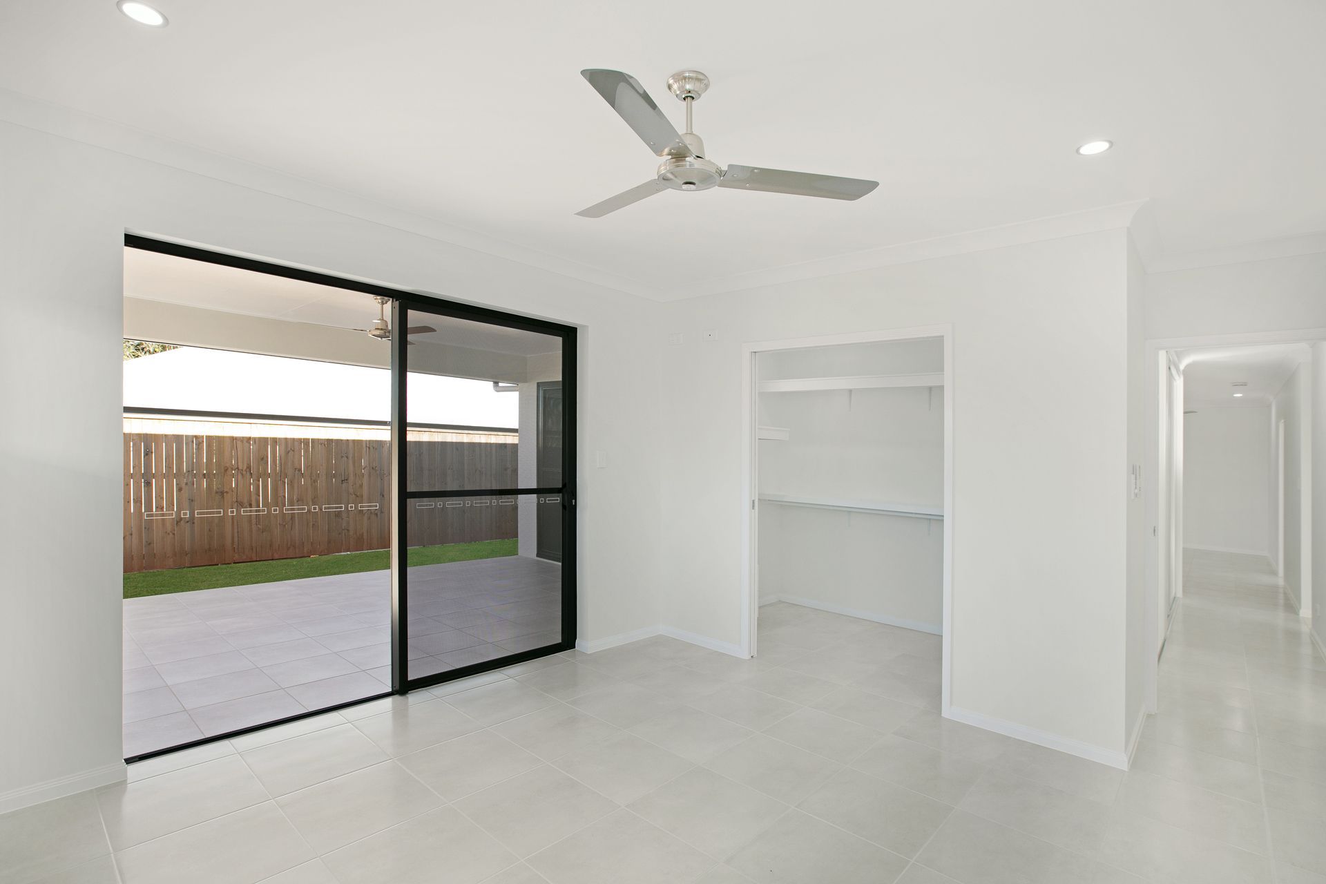A Bright, Empty Room With White Walls, Tiled Floors — Ashlee Jones Homes in Gordonvale, QLD