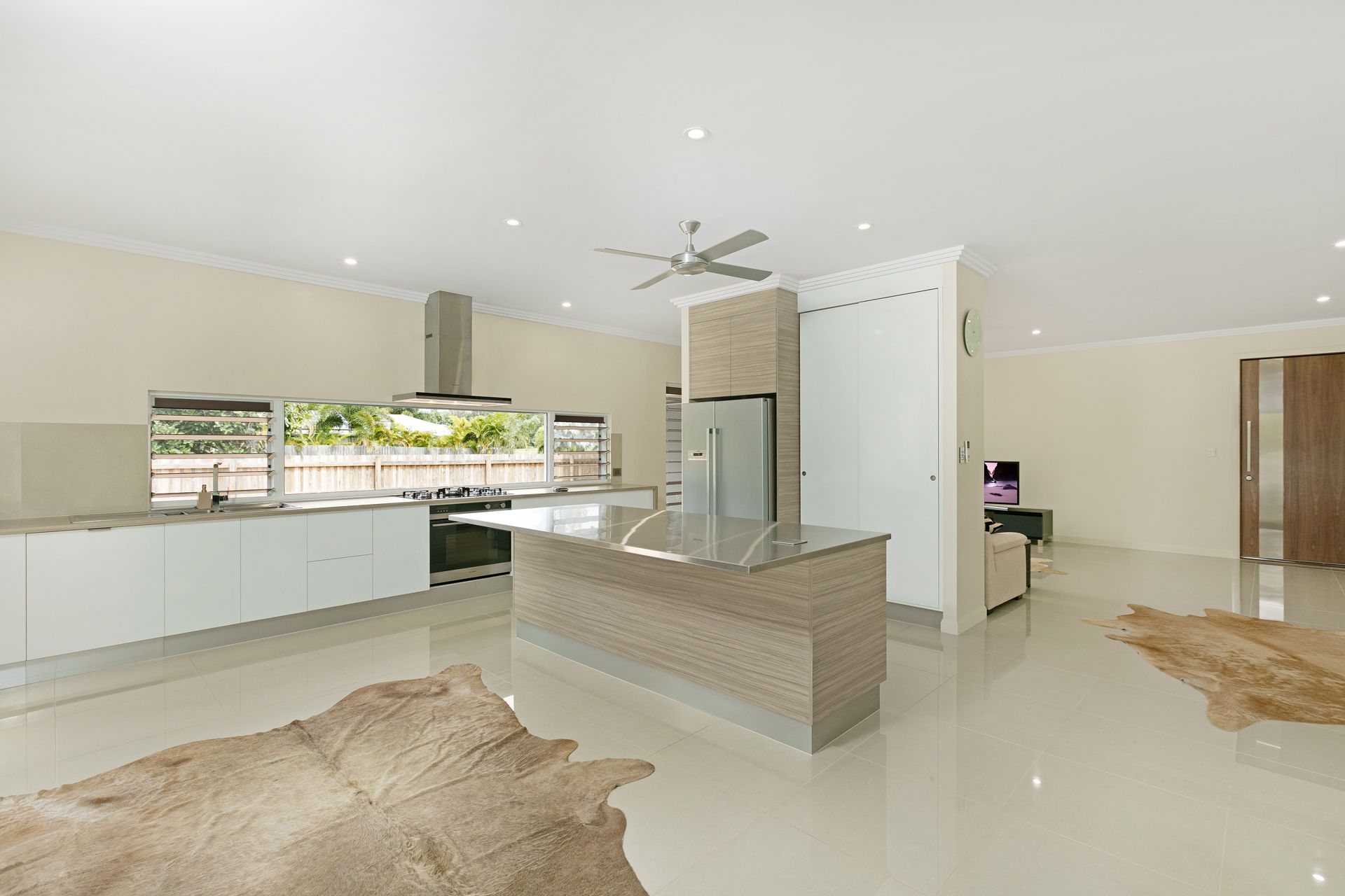 Modern Open-plan Kitchen With White Cabinetry — Ashlee Jones Homes in Gordonvale, QLD