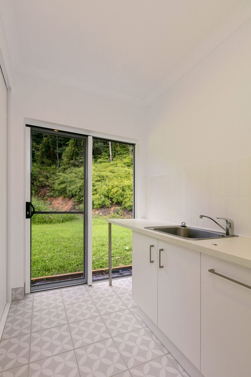 A Clean, Bright Kitchen Nook Featuring White Cabinets — Ashlee Jones Homes in Gordonvale, QLD