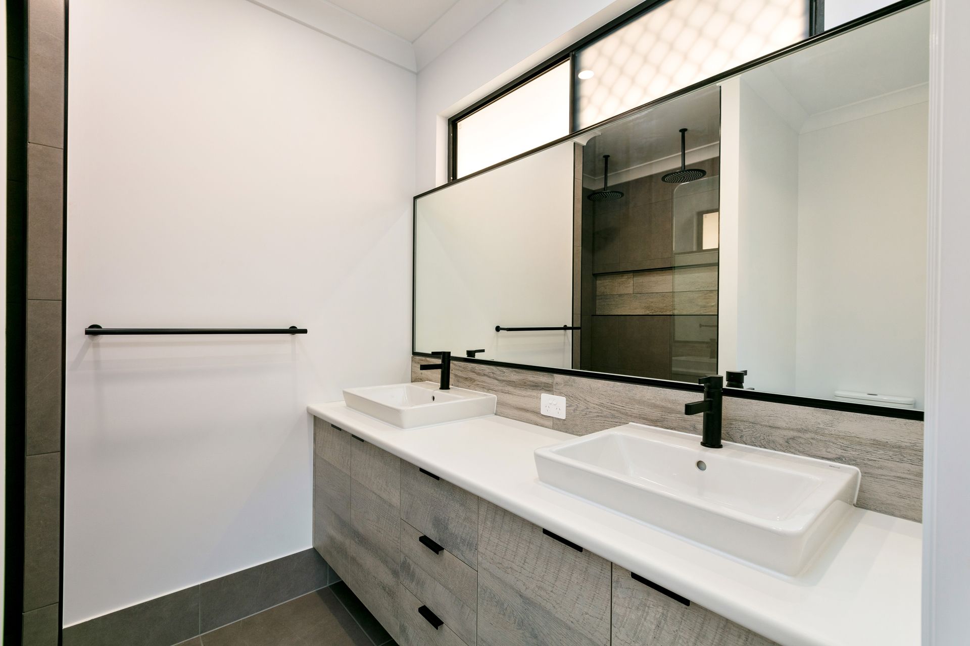 A Modern Double-sink Bathroom Vanity With White Countertops — Ashlee Jones Homes in Gordonvale, QLD