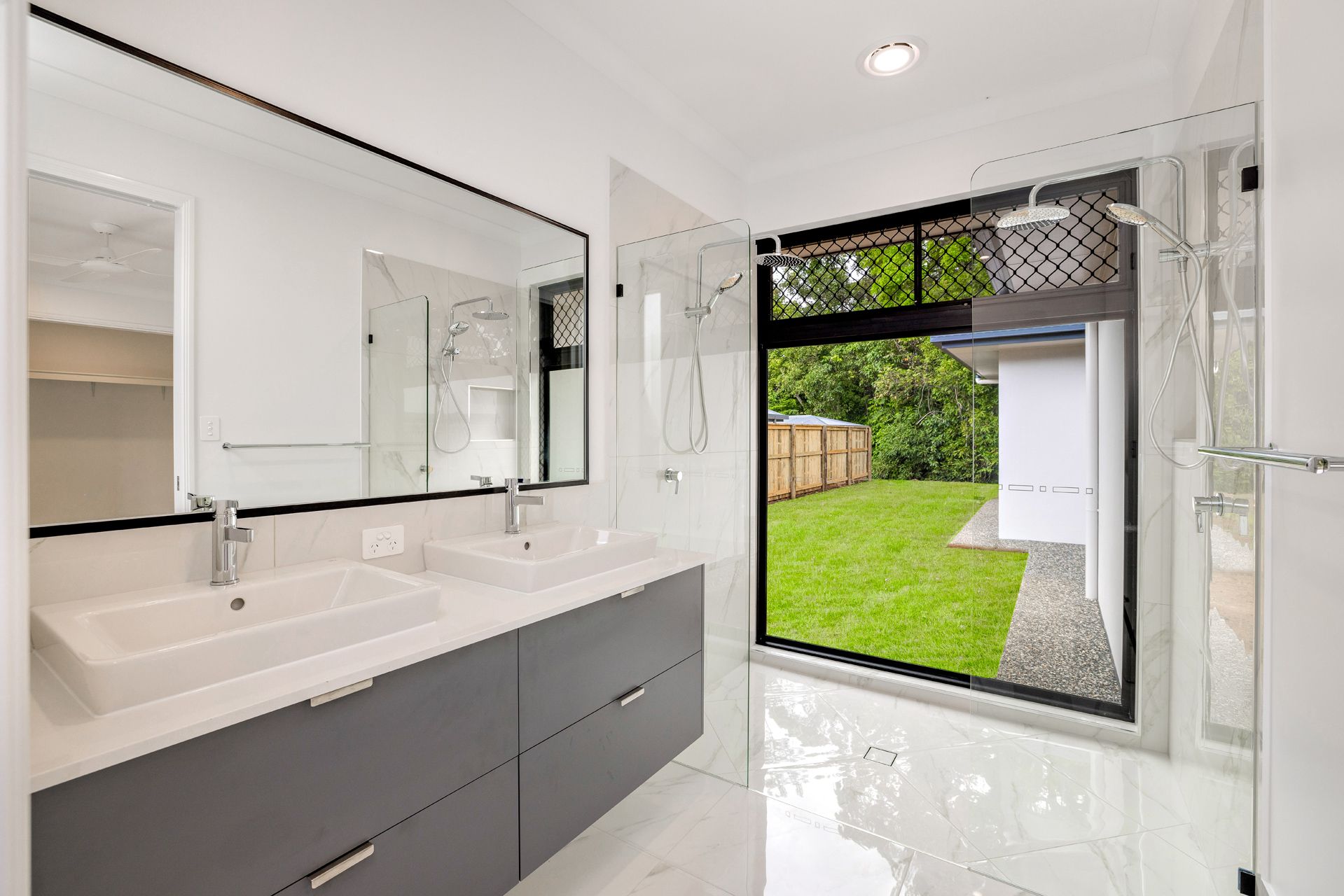 Modern Bathroom With a Double Vanity, Large Mirror — Ashlee Jones Homes in Gordonvale, QLD