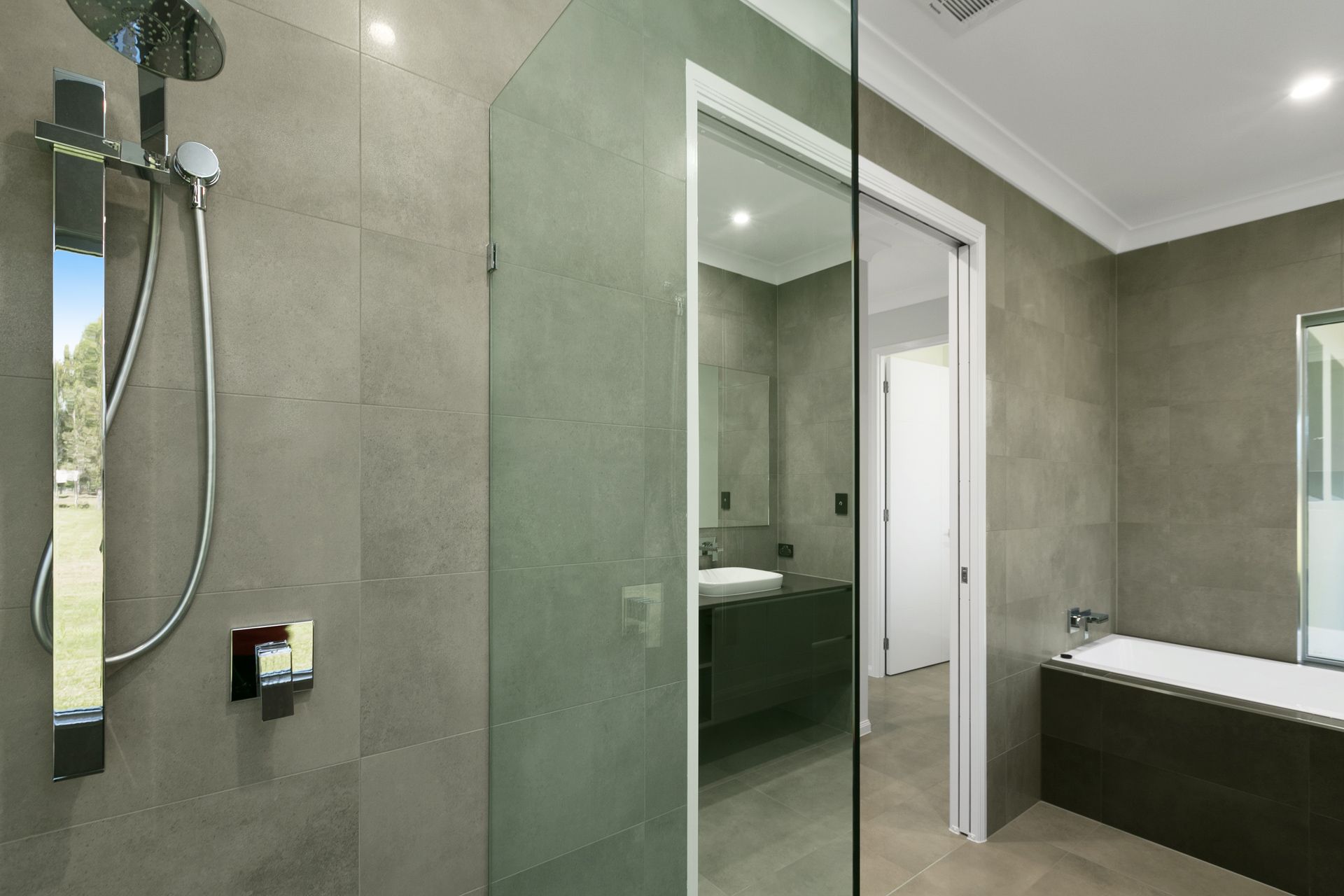 A Modern Bathroom With a Glass-enclosed Shower — Ashlee Jones Homes in Gordonvale, QLD