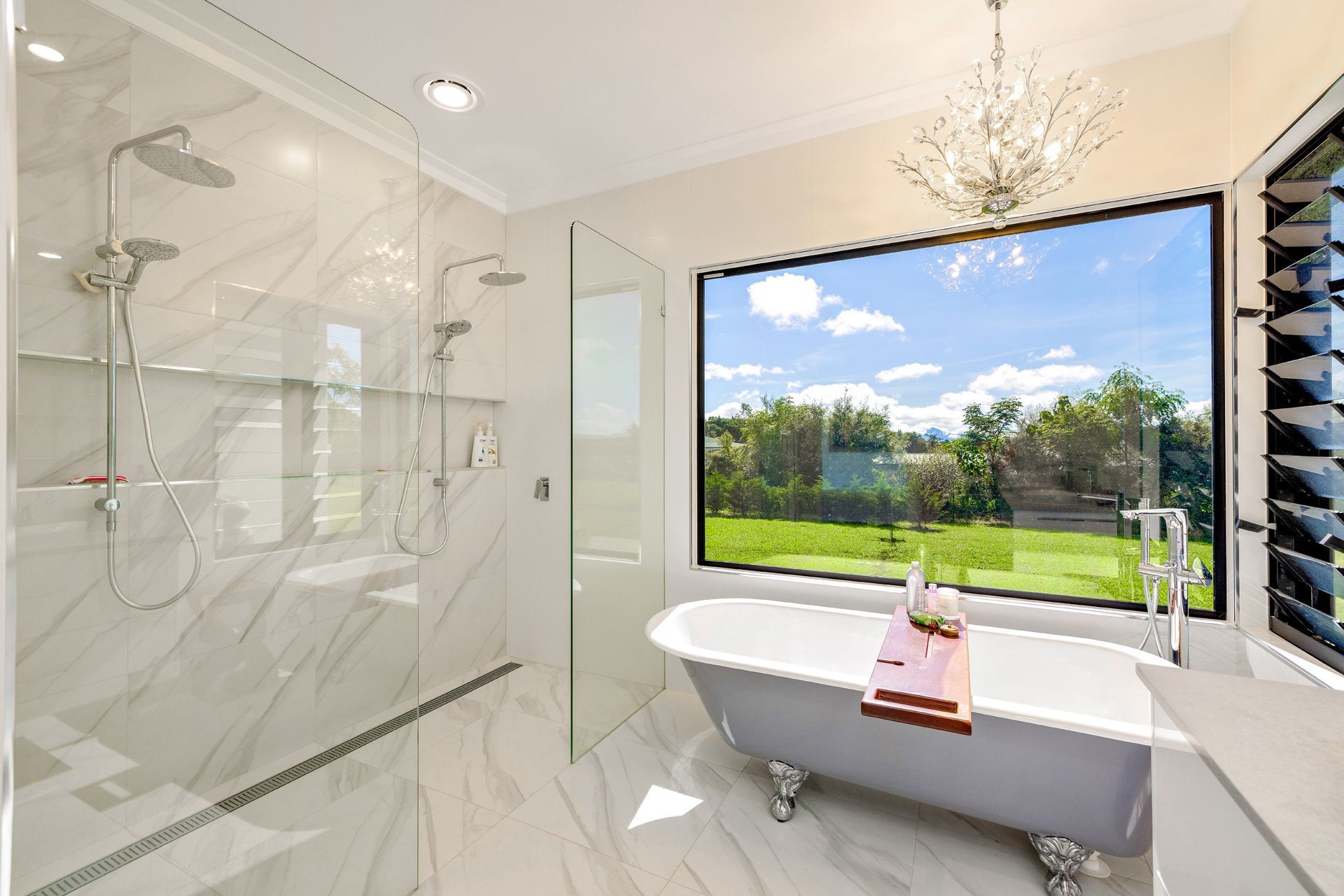 A Modern Bathroom Featuring a Walk-in Glass Shower — Ashlee Jones Homes in Gordonvale, QLD