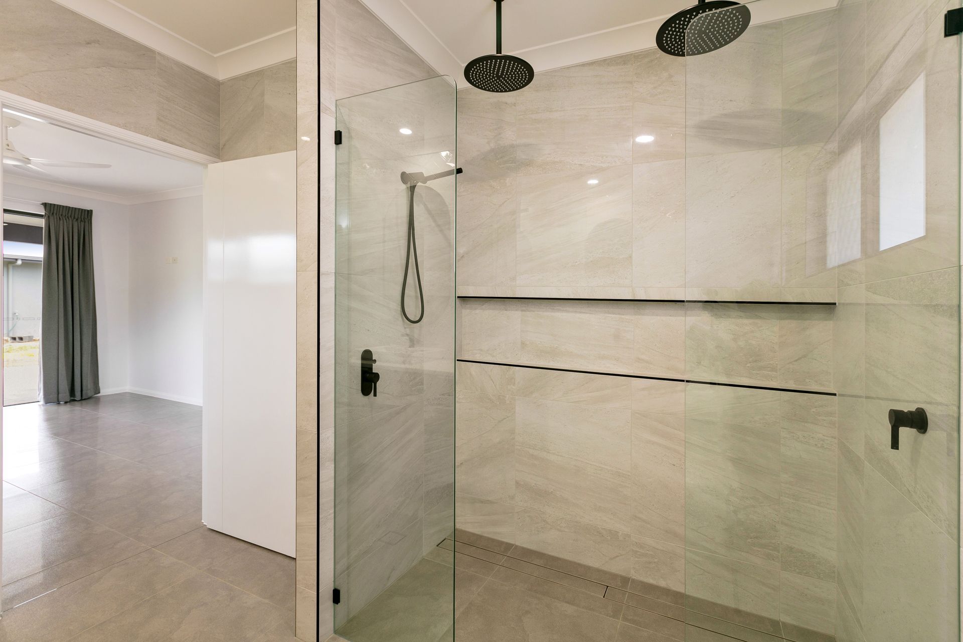 A Modern Walk-in Shower With Light Marble-patterned Tiles — Ashlee Jones Homes in Gordonvale, QLD