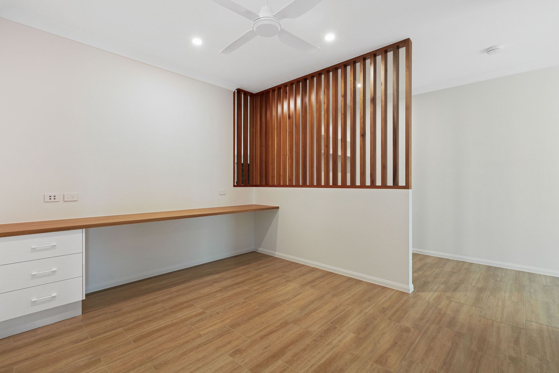 A Home Office Nook With a Built-in Wooden Desk — Ashlee Jones Homes in Gordonvale, QLD